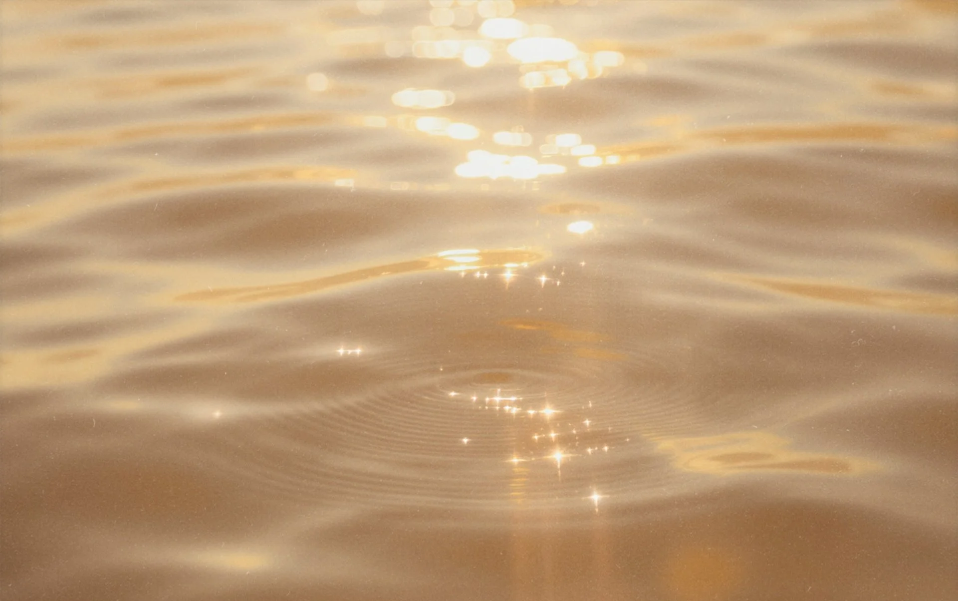 Close-up of sunlight reflecting on the surface of water with gentle ripples.