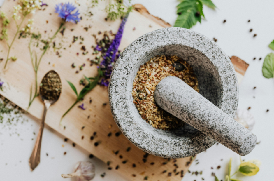 Mortal and pestle with herbs.