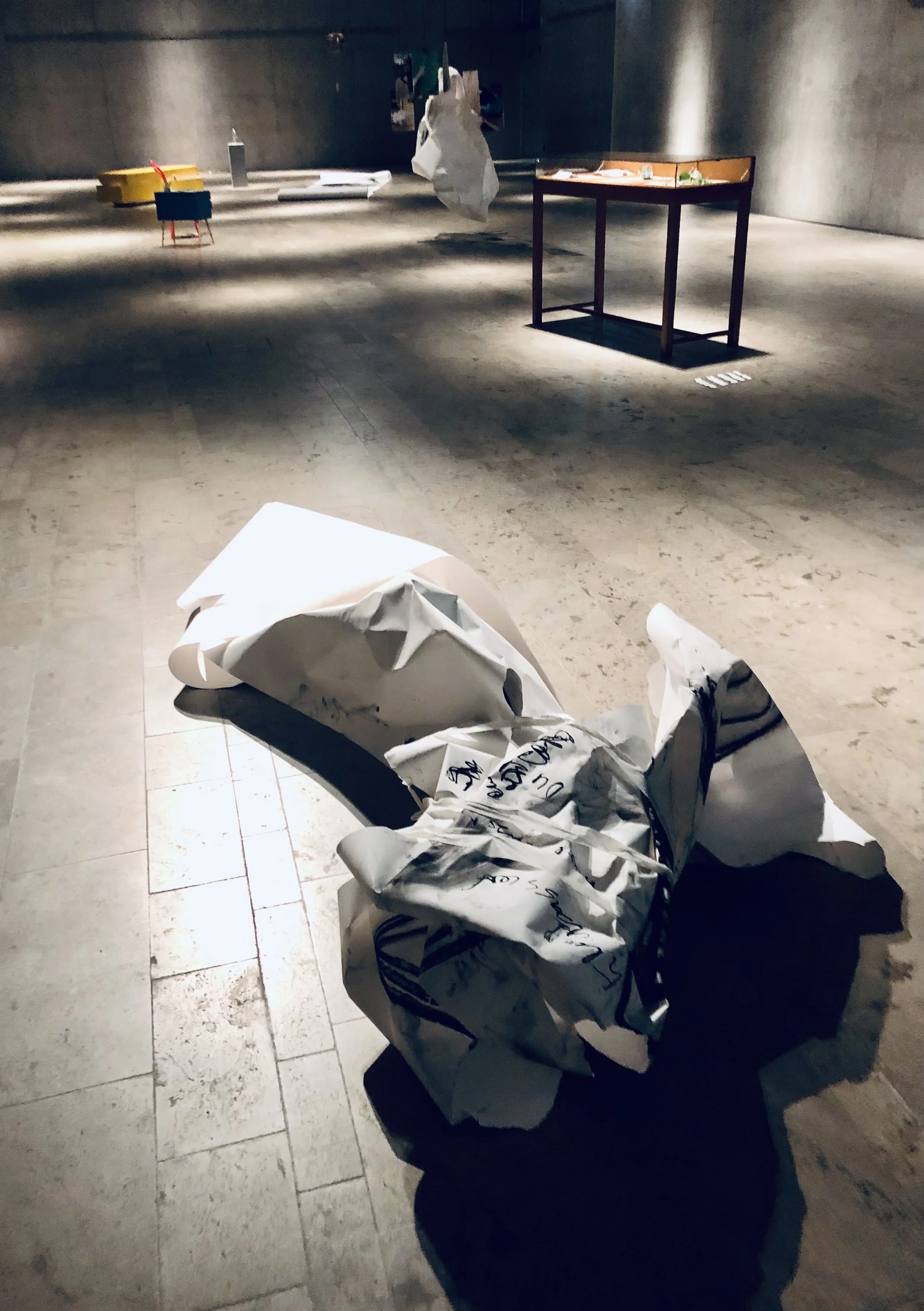 Installation DAS VERSCHWINDEN im SMAEK mit Papierknäuel im Vordergrund