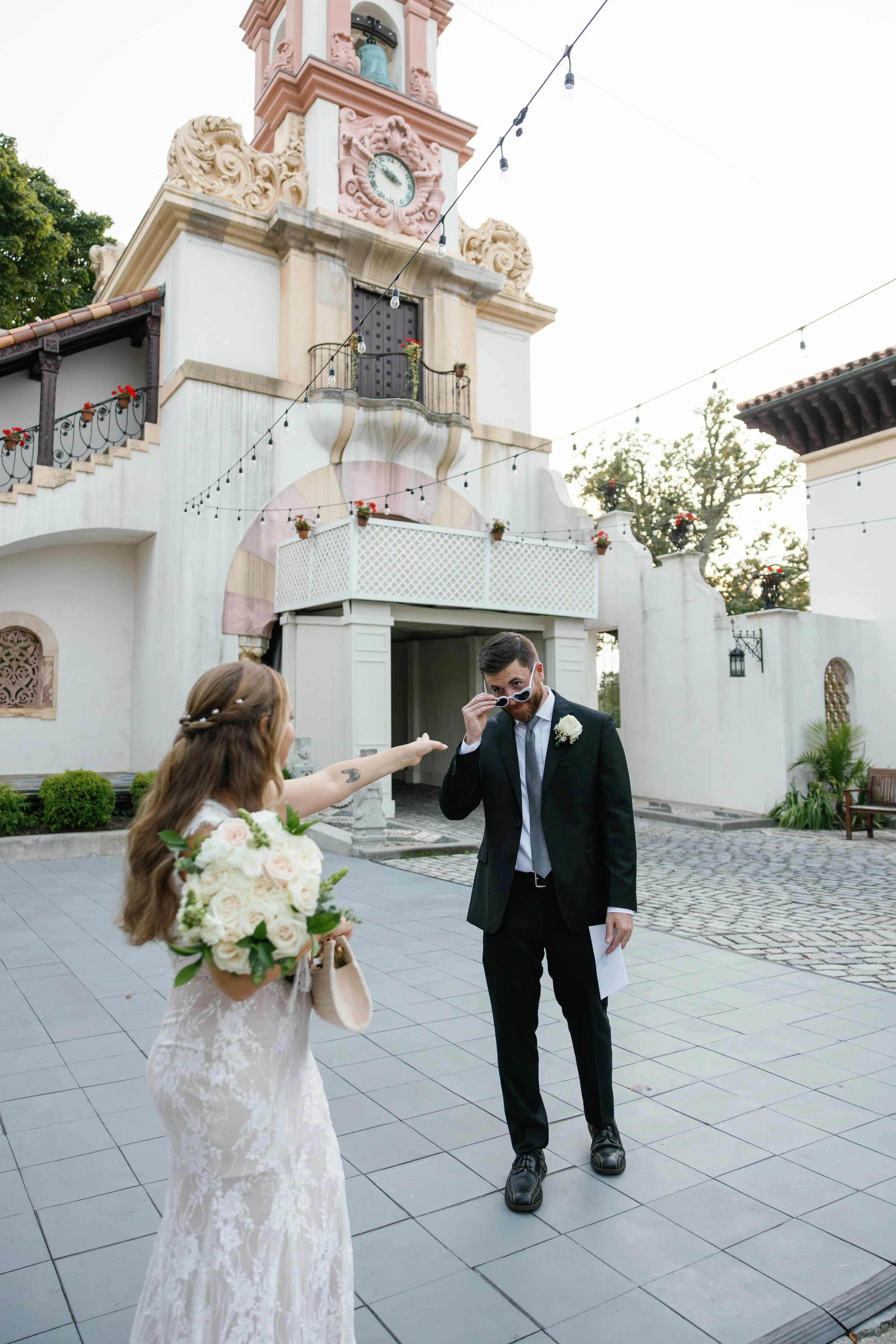 Bride and groom during a romantic South Florida elopement ceremony outside a historic pink mansion, planned by Pop-Up Vows for a small wedding experience.