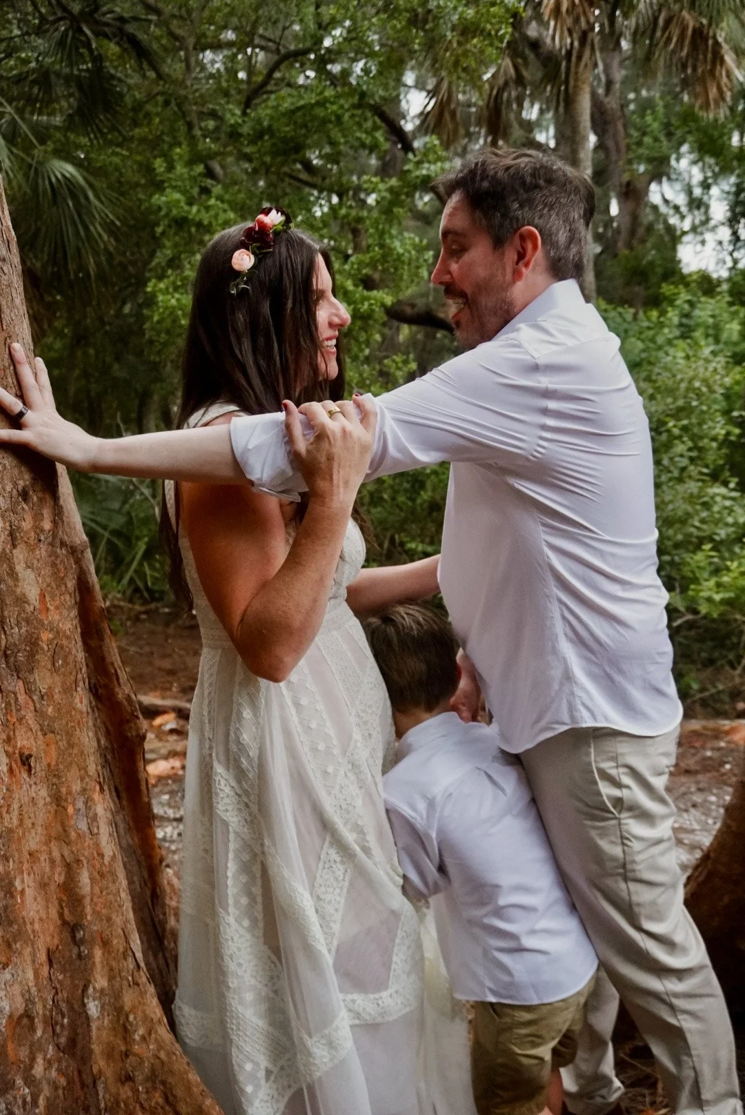 A couple and a child beneath the banyan trees at Atlantic Dunes in Delray Beach.