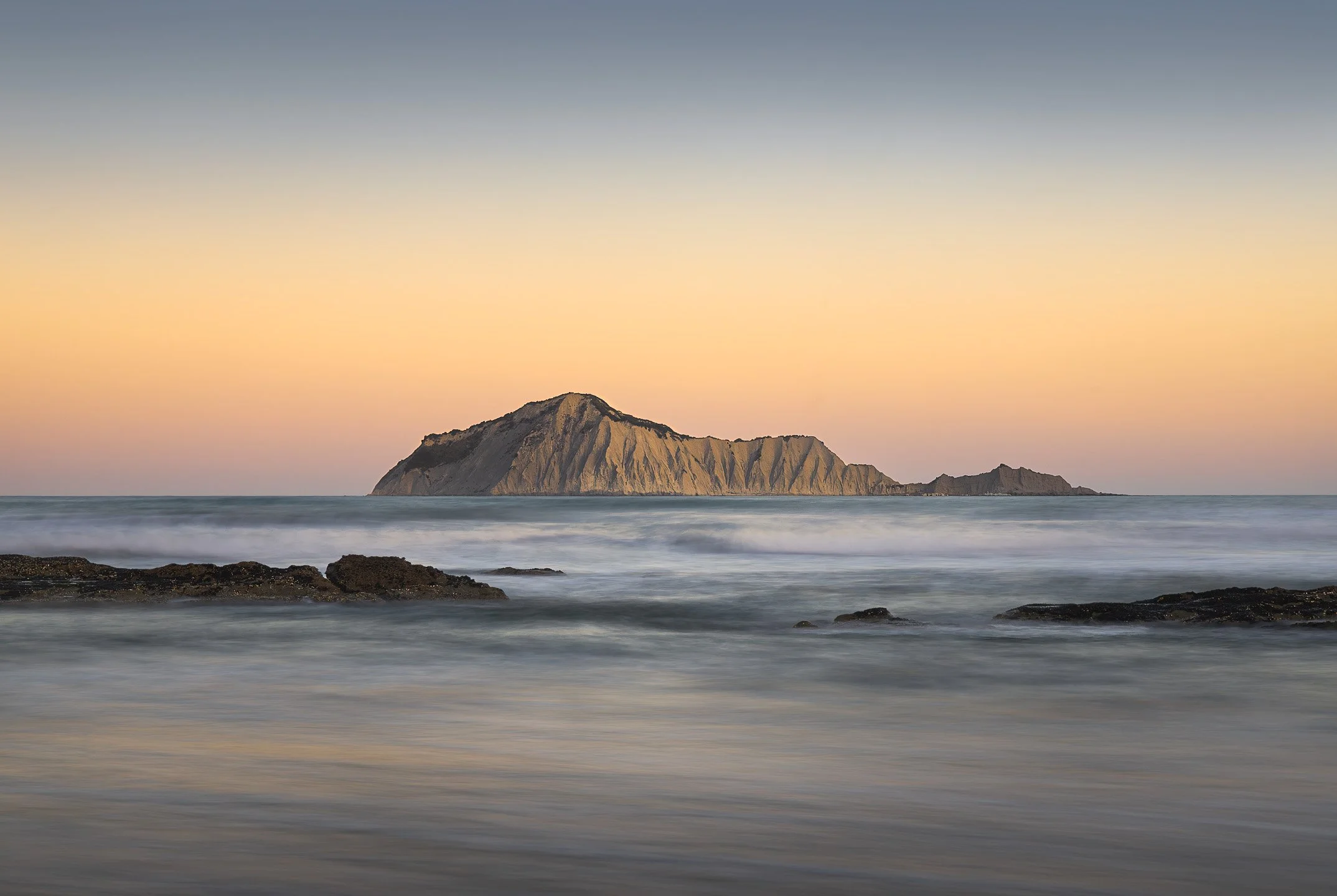 Sunset long exposure of Bare Island (Motu-o-Kura) and reef at Waimarama Beach, Hawke's Bay, New Zealand