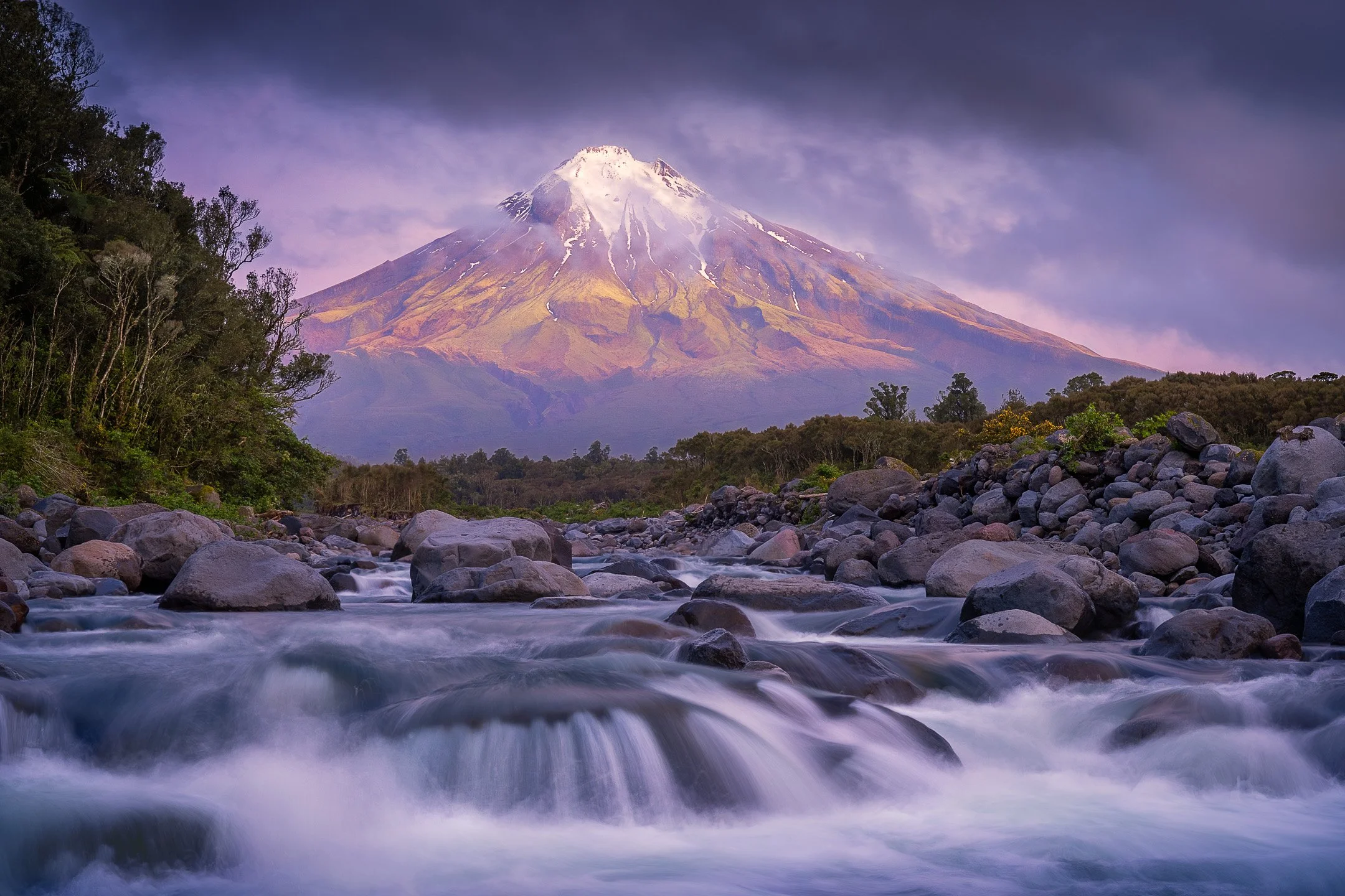 Taranaki Maunga revealed by lifting cloud above the Stony River at dusk, New Zealand