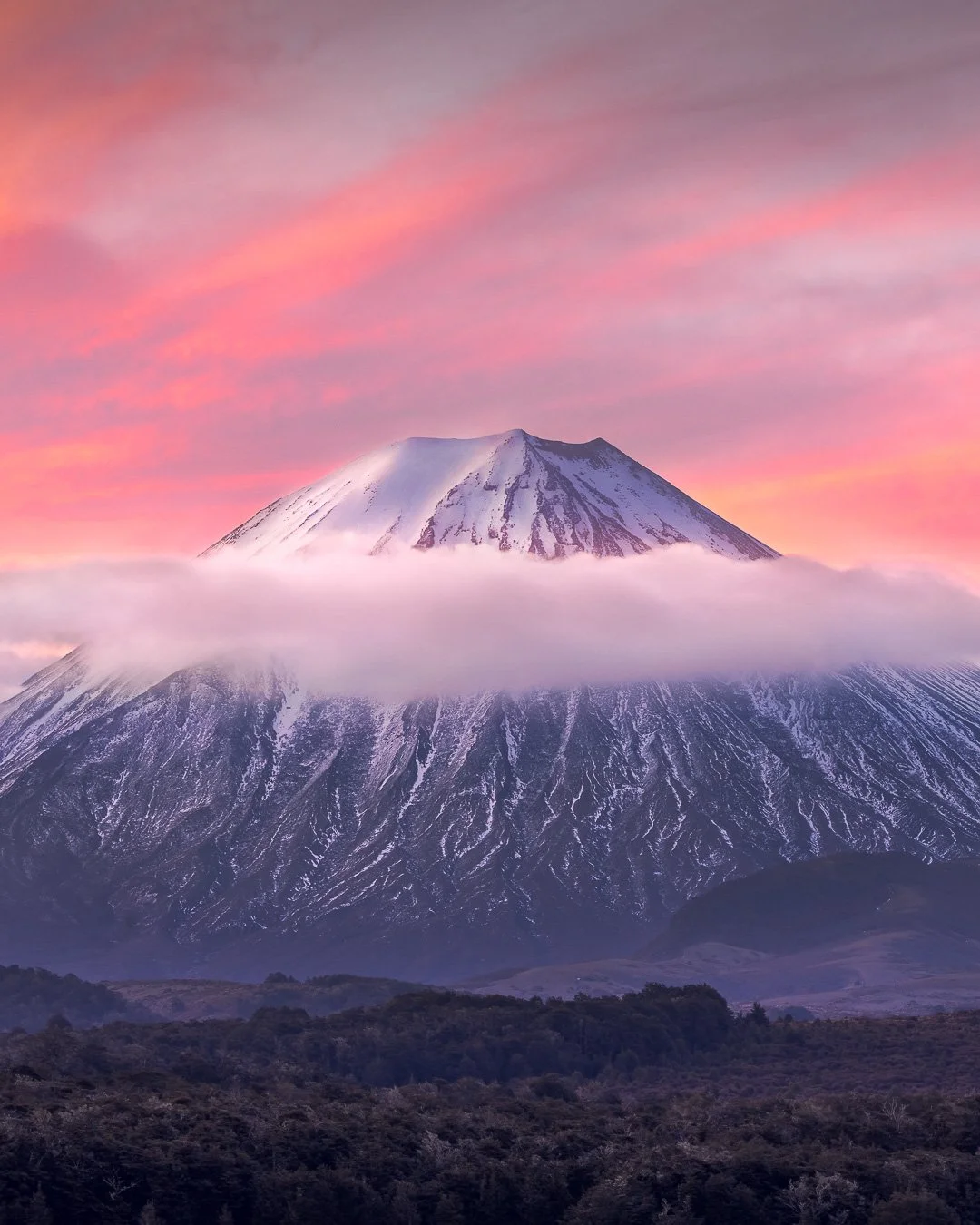 Cone Division - Tongariro National Park.

The volcanic cone of Mount Ngauruhoe encircled by clouds during a colourful sunset.