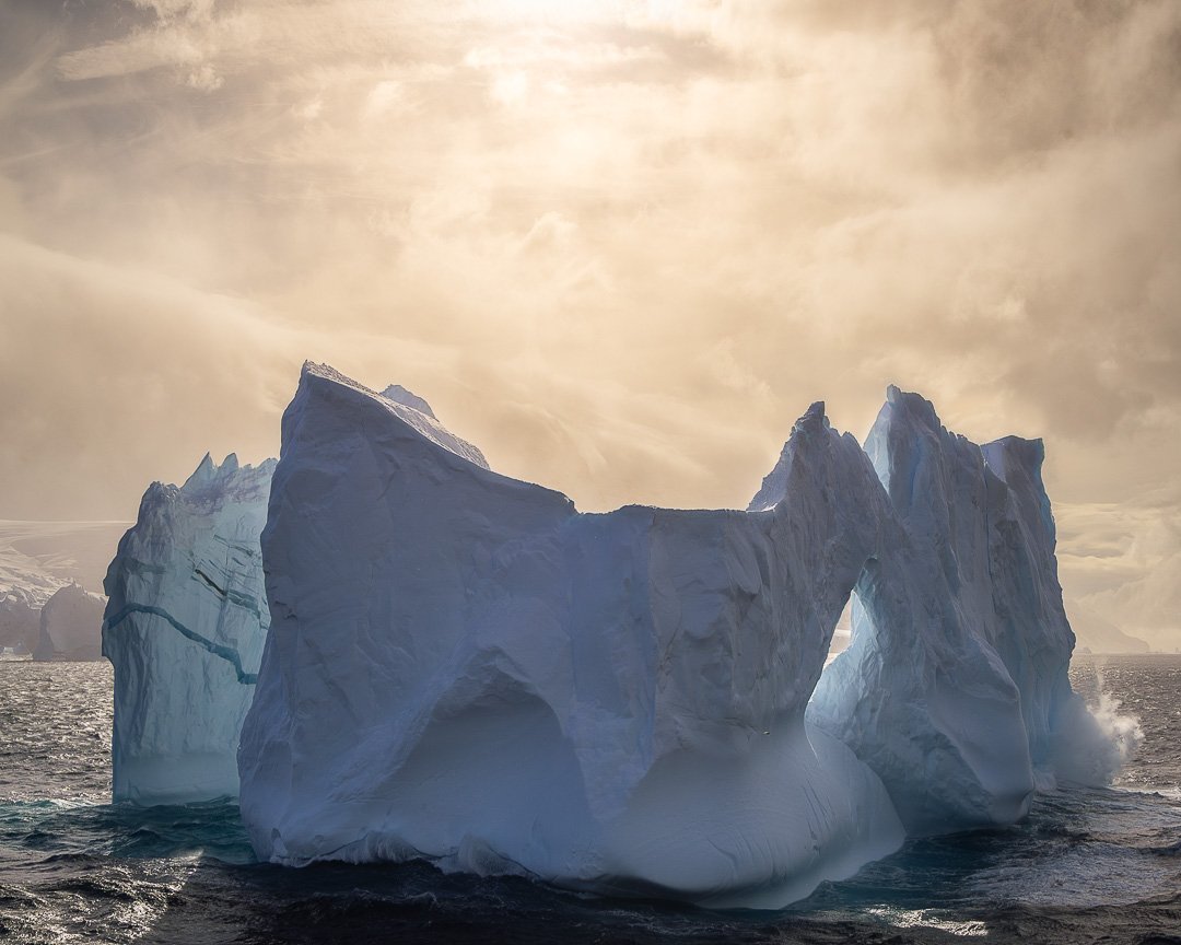 The Gateway - Balleny Islands, Antarctica.

On the return passage through the Balleny Islands, we were circling an iceberg I had already photographed in grey, overcast light. Then the clouds broke completely. And as the ship turned, the other side of