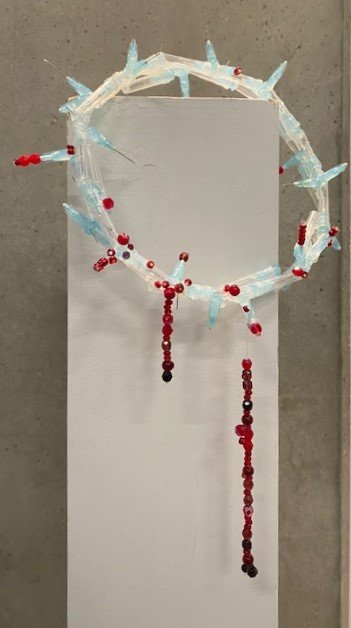 'iii', testosterone needles, hot glue, glass beads, fishing line. 2024. 