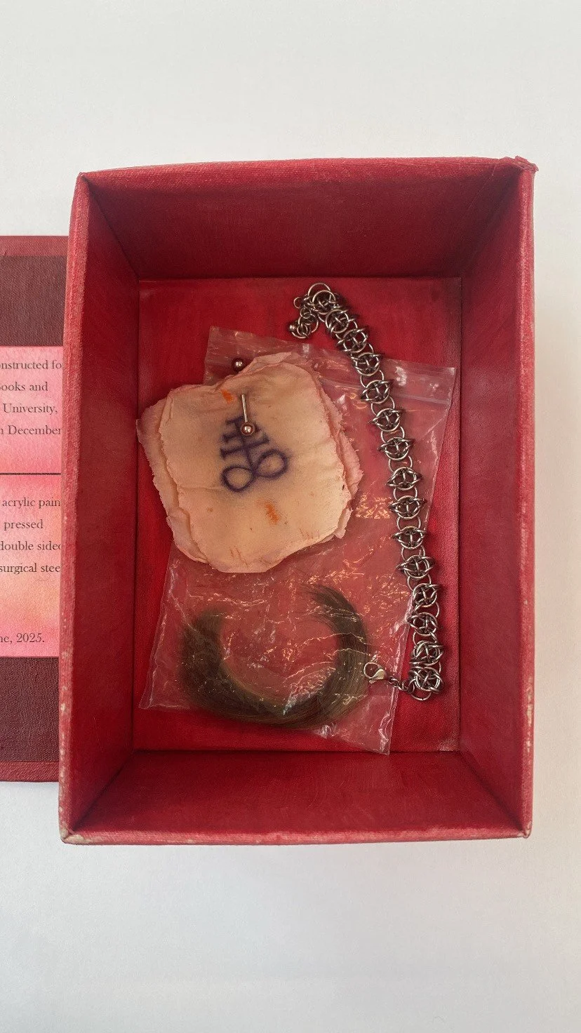 'SUNBURN' Artist Book, liquid latex, EVA paper, acrylic paint, loose setting powder, pressed eyeshadow, cloth fabric, double sided tape, satin sealant, 6mm surgical steel jump rings, steel labret, human hair. 2024. 