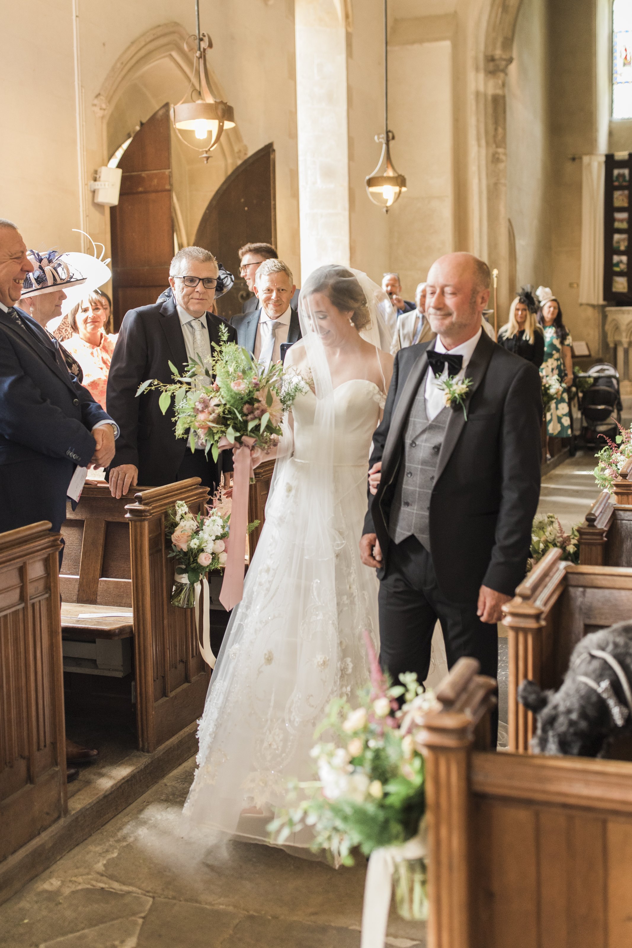  bride walking down the aisle in church with father 
