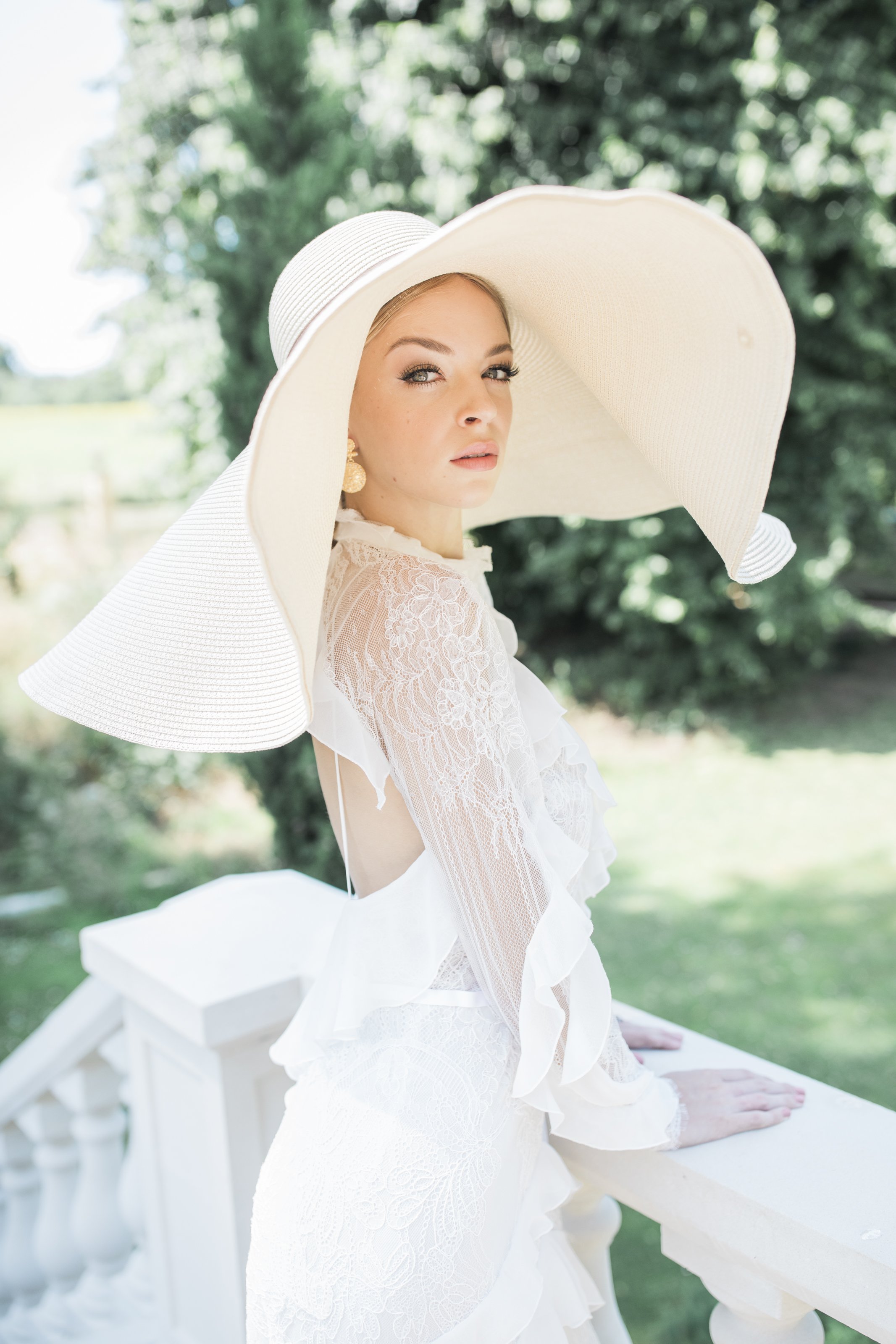 Bride with large hat at The Old Rectory Estate wedding venue