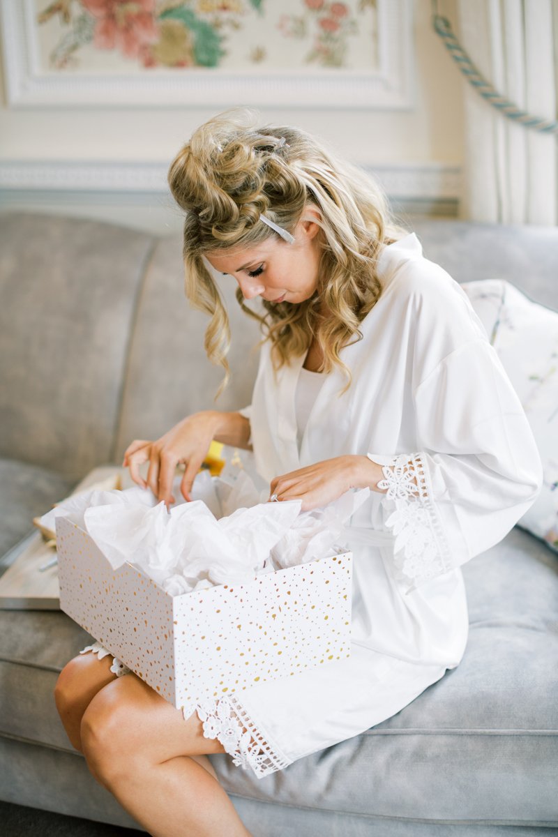 bride opening present in the bridal suite at Hedsor House