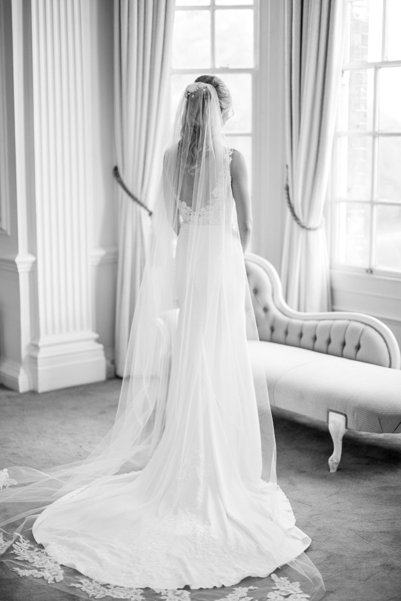 Bride sitting by window at Hedsor House