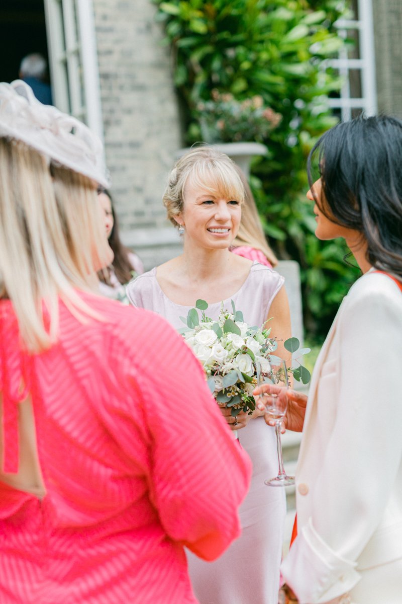 Bridesmaid talking to guests