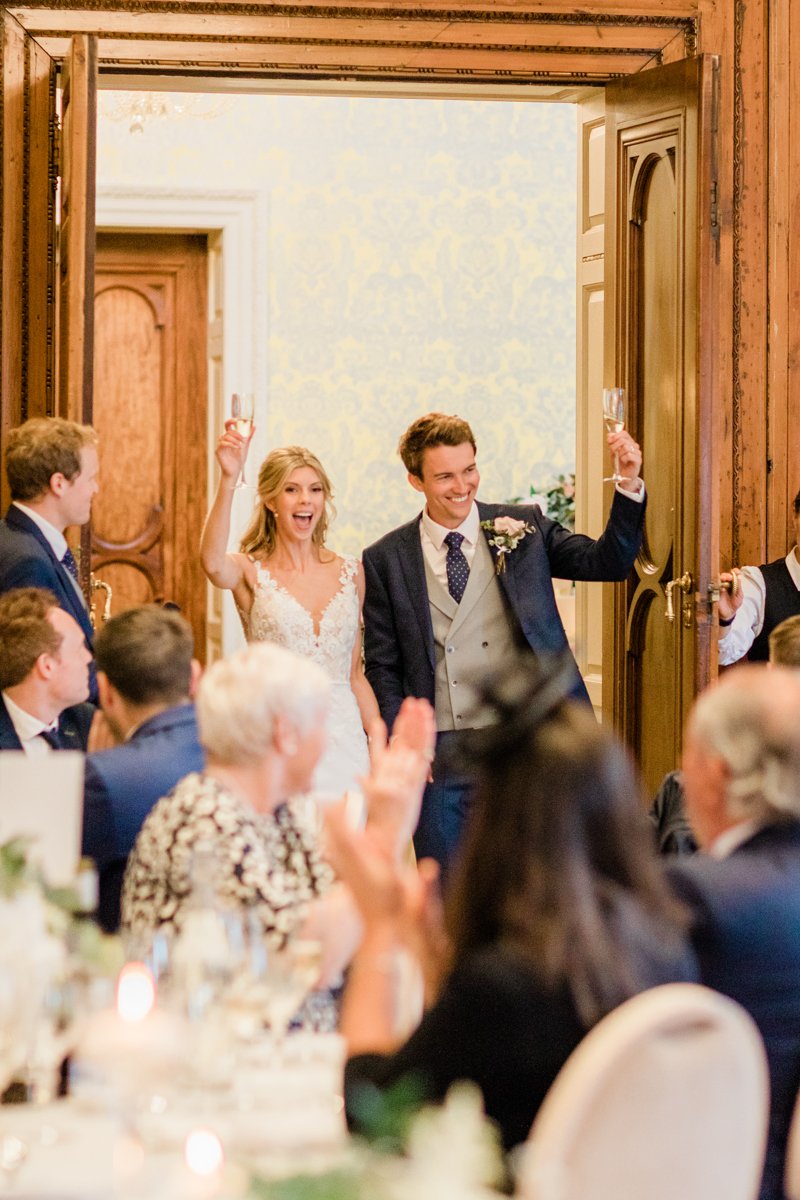 Bride and Groom walking in to the ballroom at Hedsor House