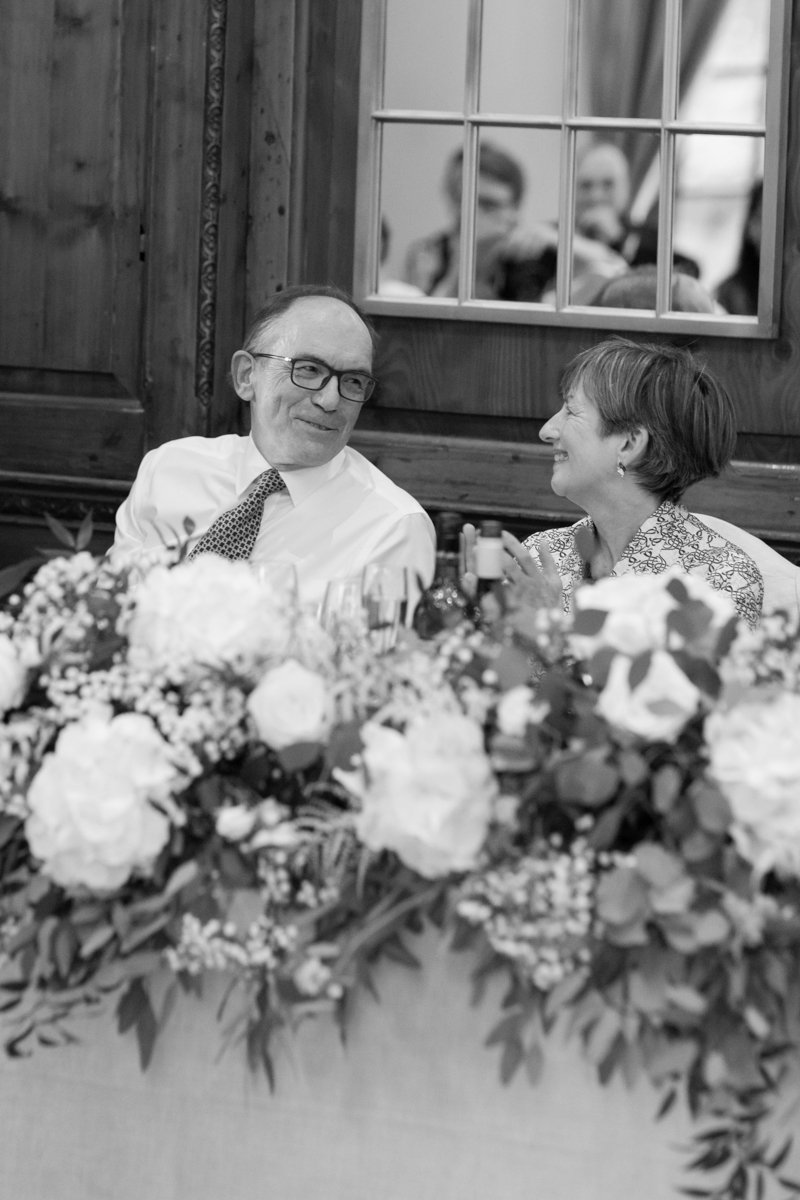 guests laughing to wedding speeches