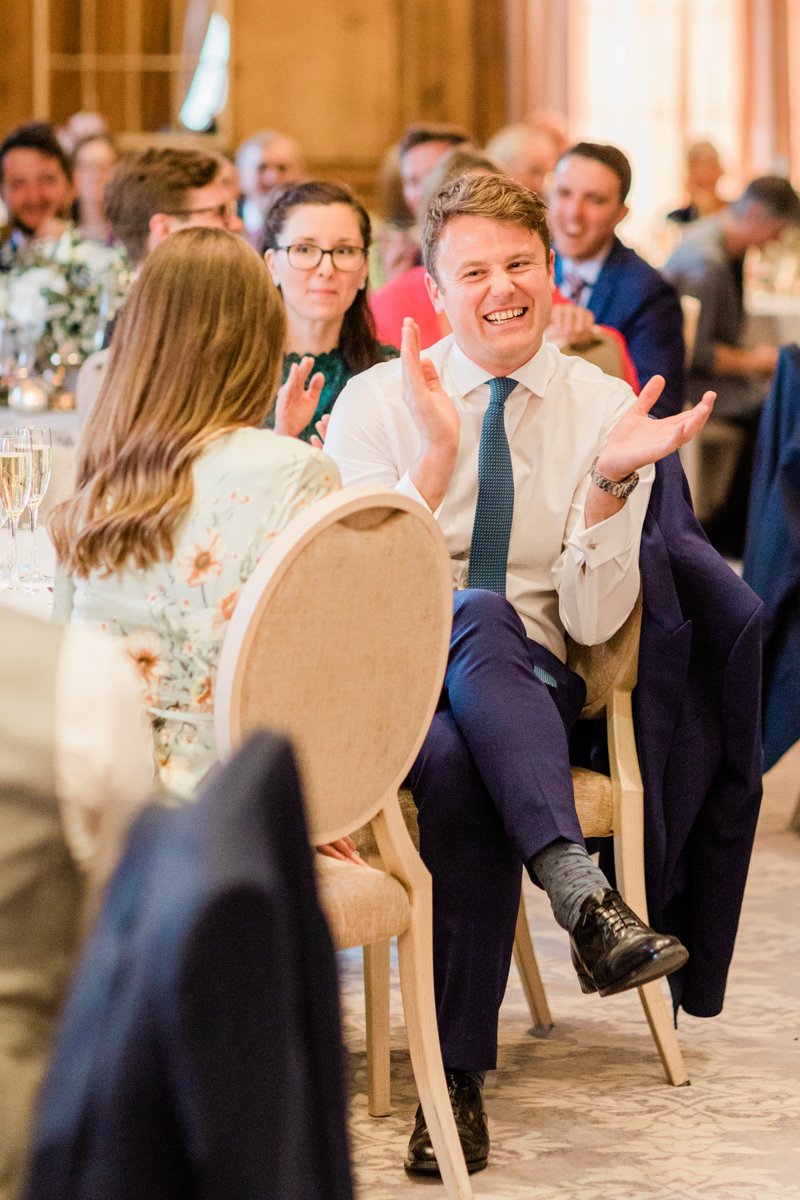 guests laughing to wedding speeches