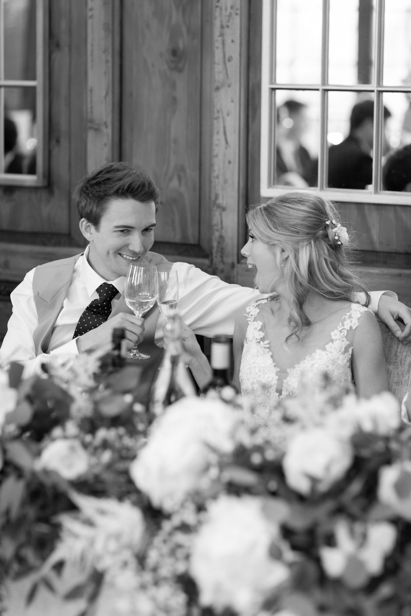 Bride and Groom laughing to speeches