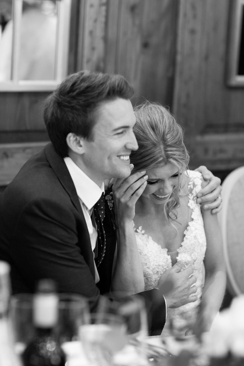 bride and groom laughing and hugging each other