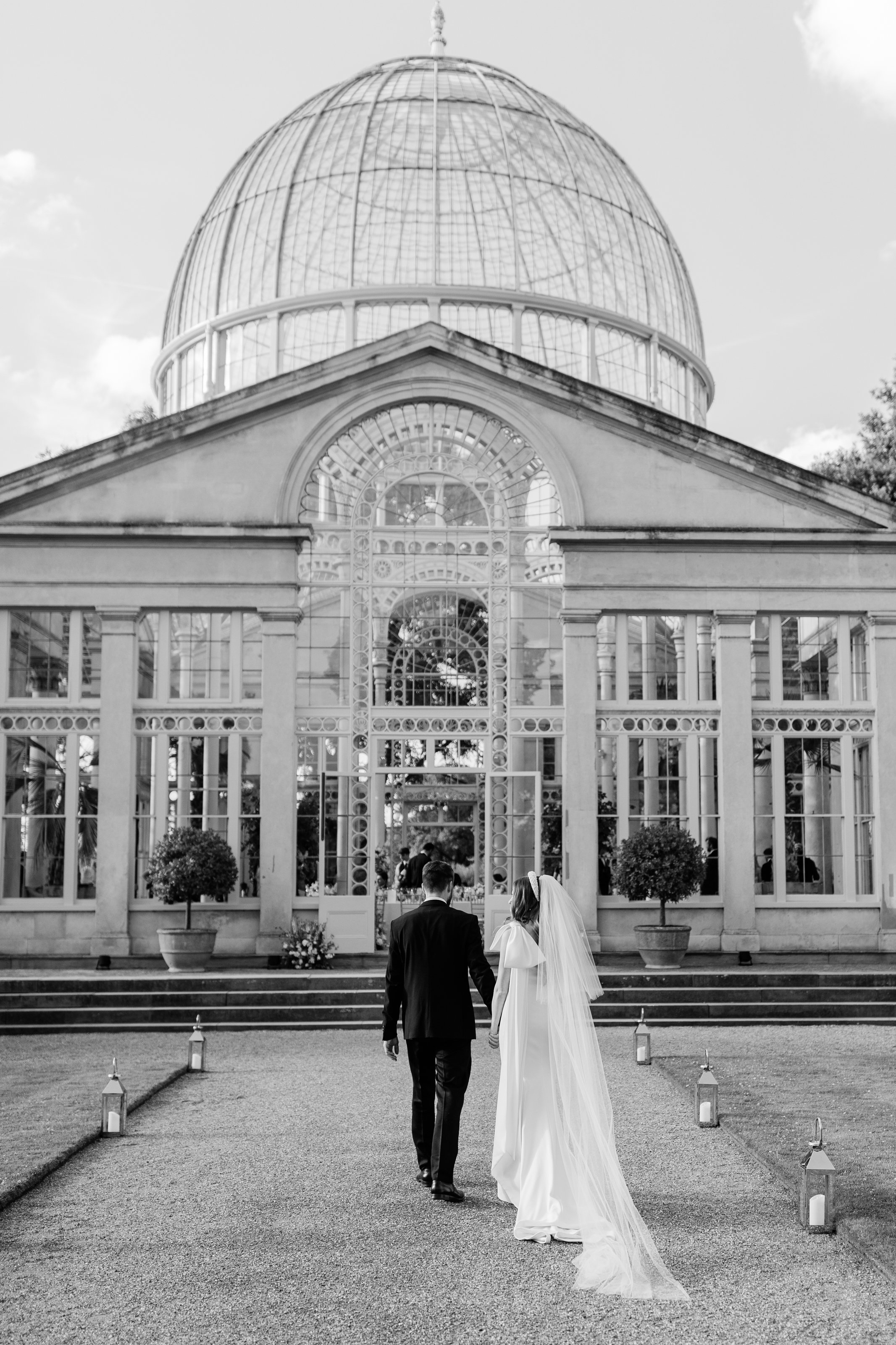 Bride and groom walking to the conservatory at Syon Park