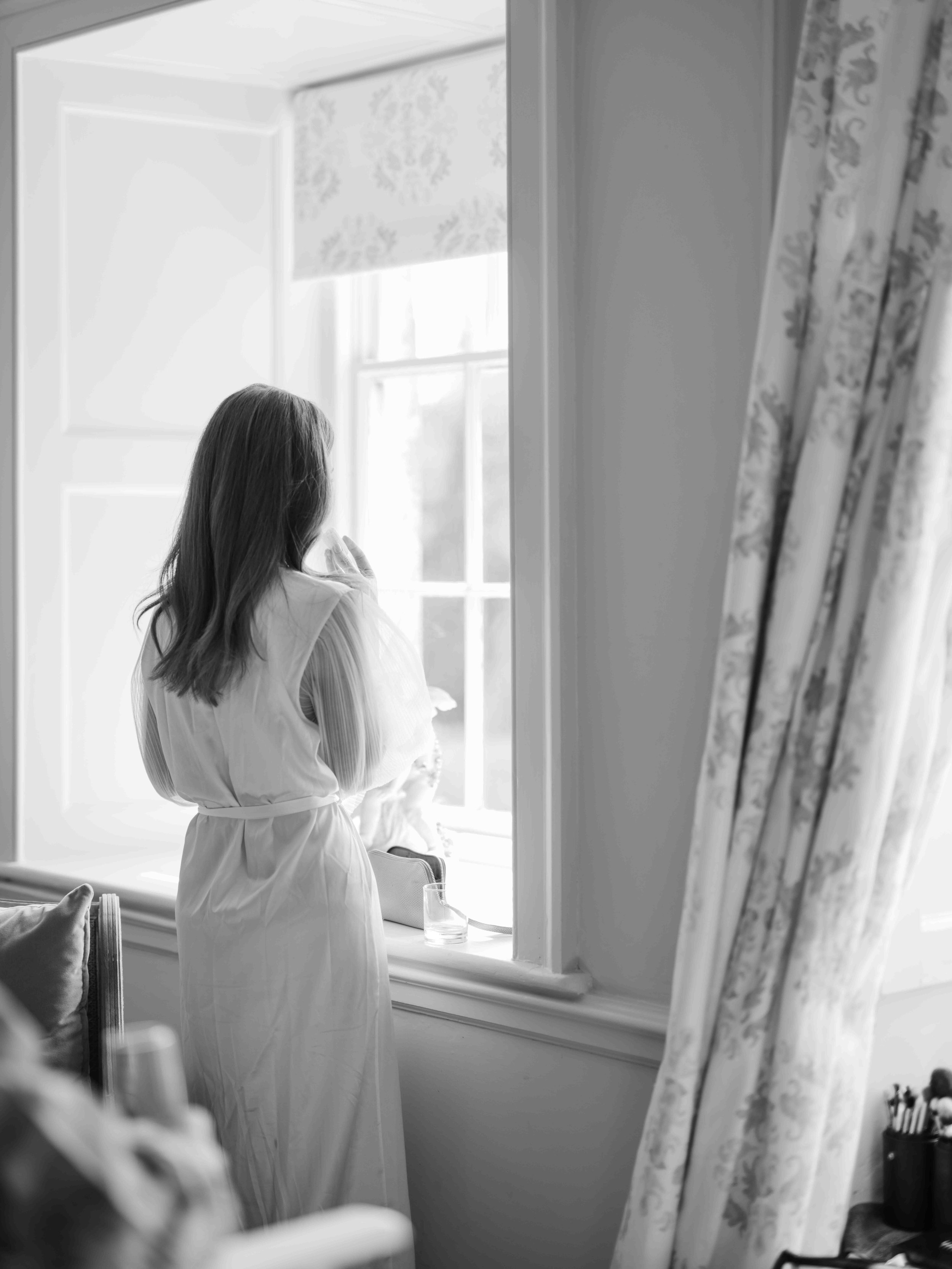  Bride looking outside bridal suite window at Came House 