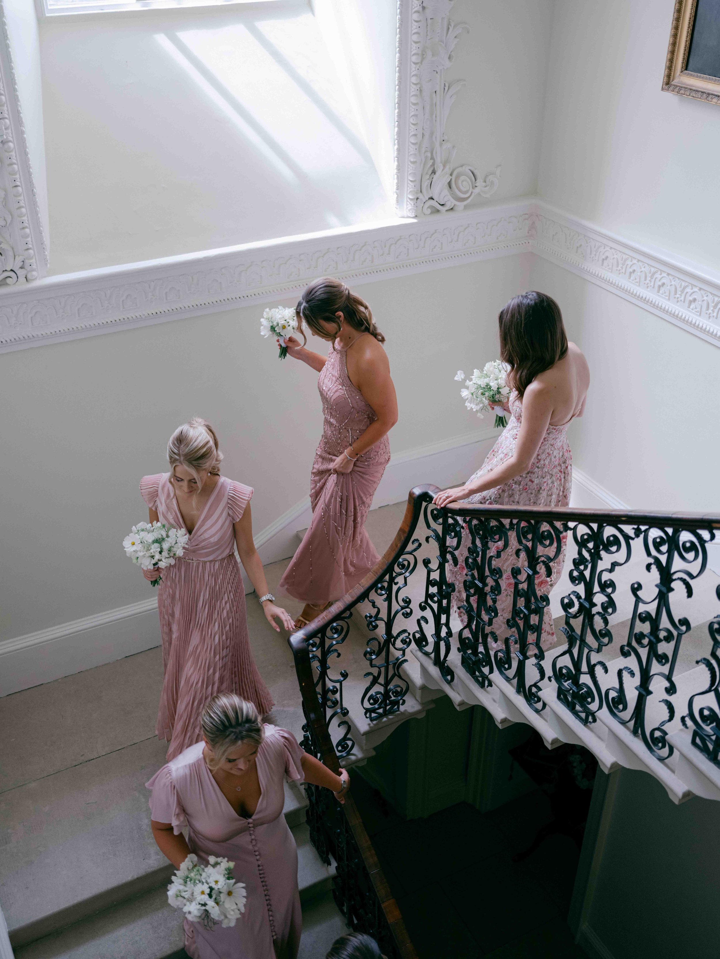  Bridesmaids walking down the stairs at Came house 