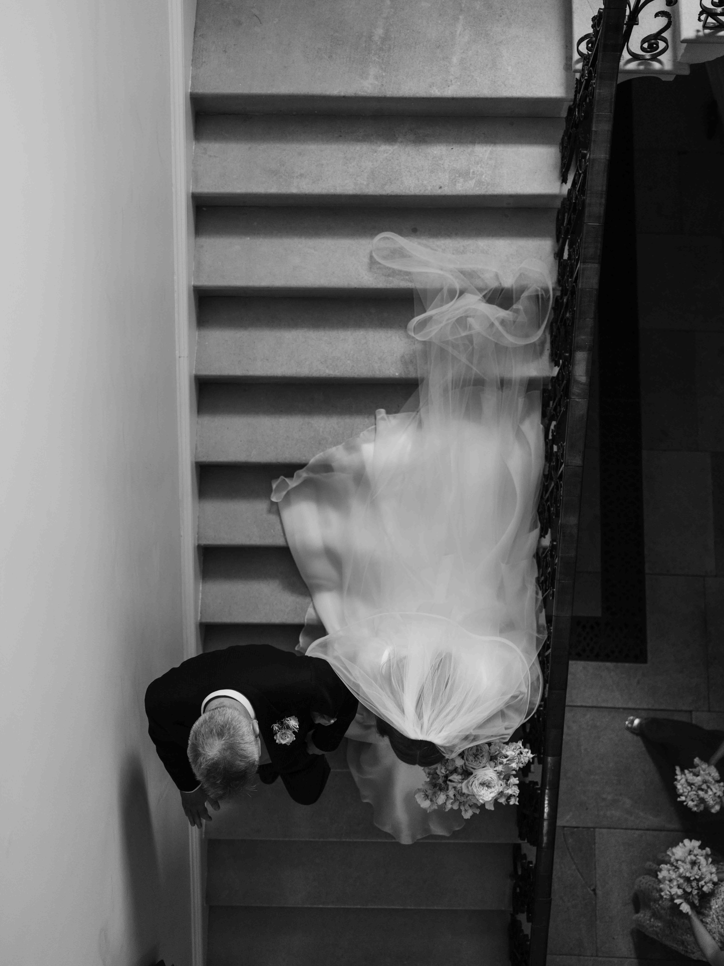  Bride and Groom walking down the stairs 