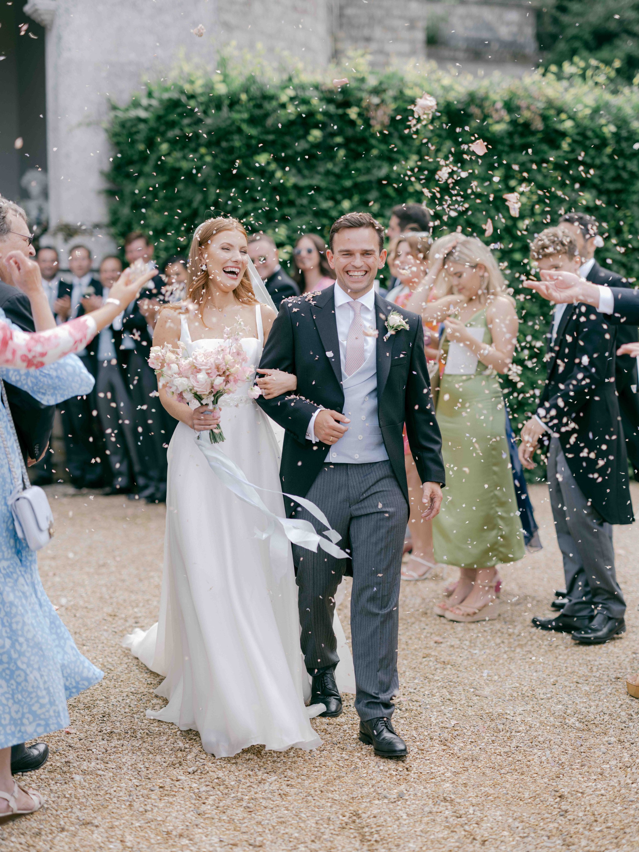  Bride and Groom walking with confetti being thrown over them at Came House 