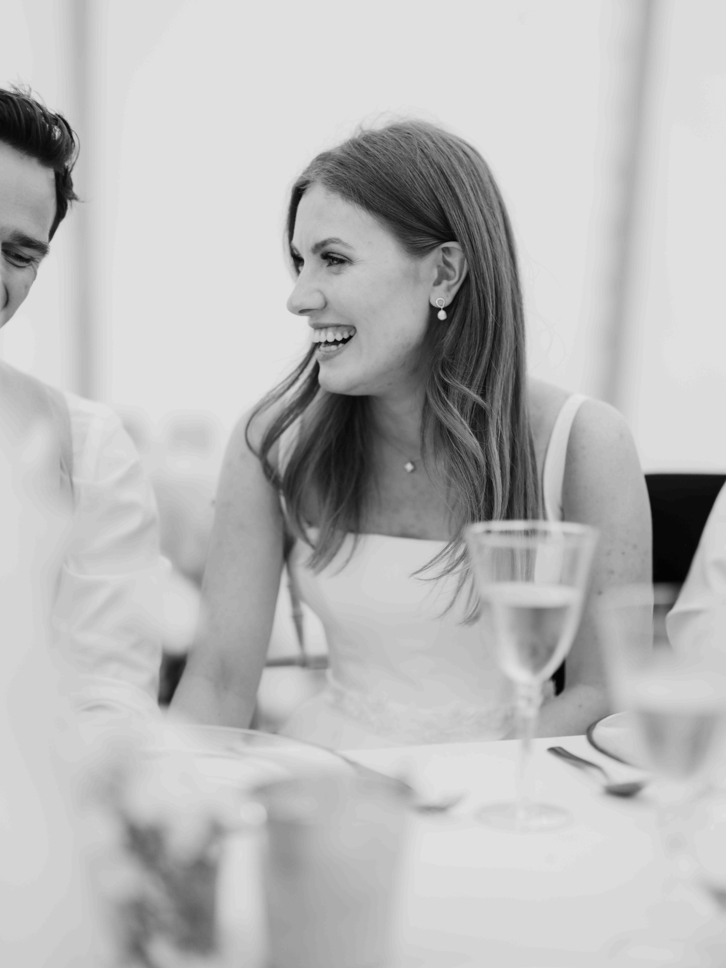  black and white photo of bride laughing 