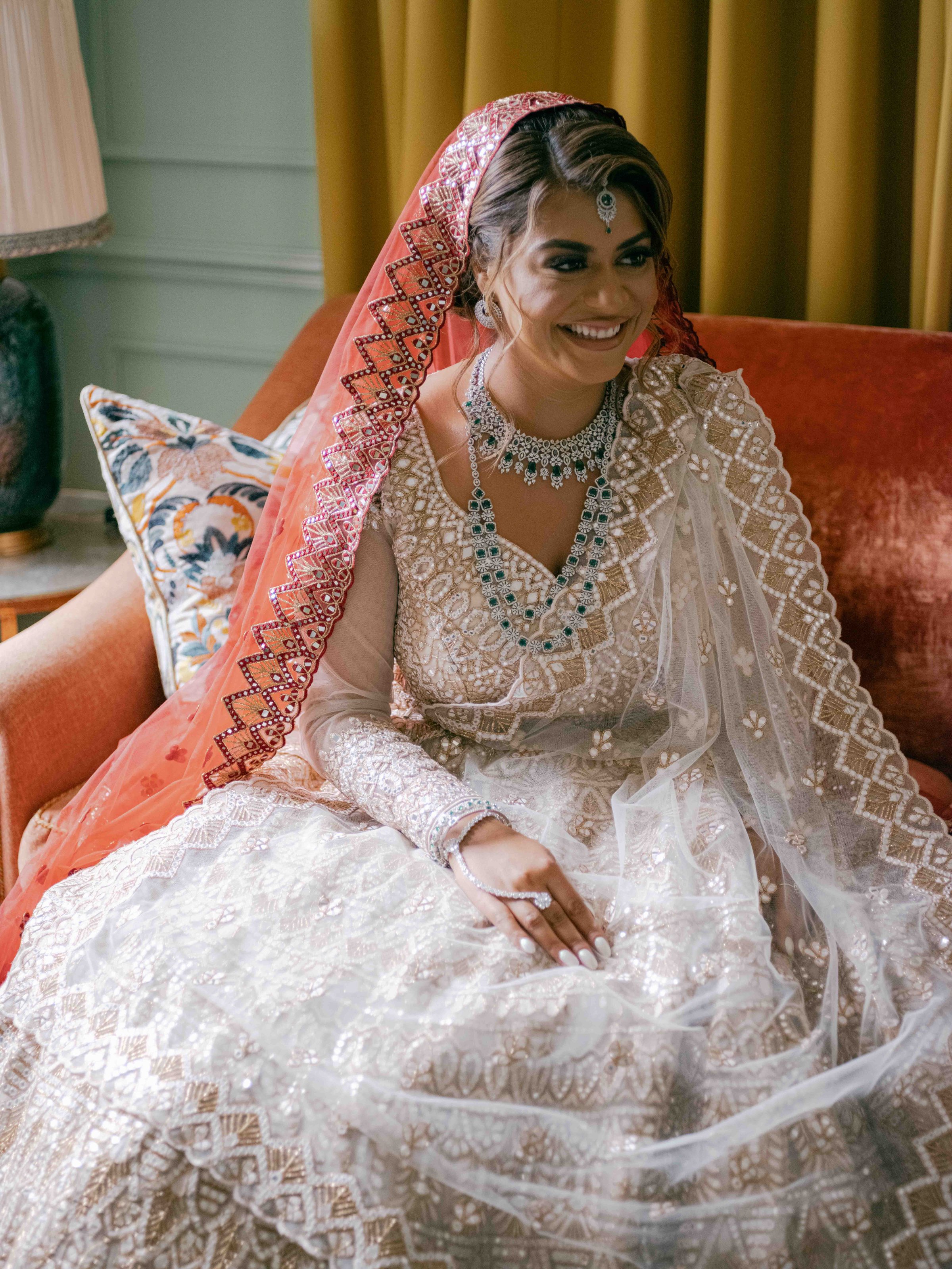  bride smiling sitting on a sofa 