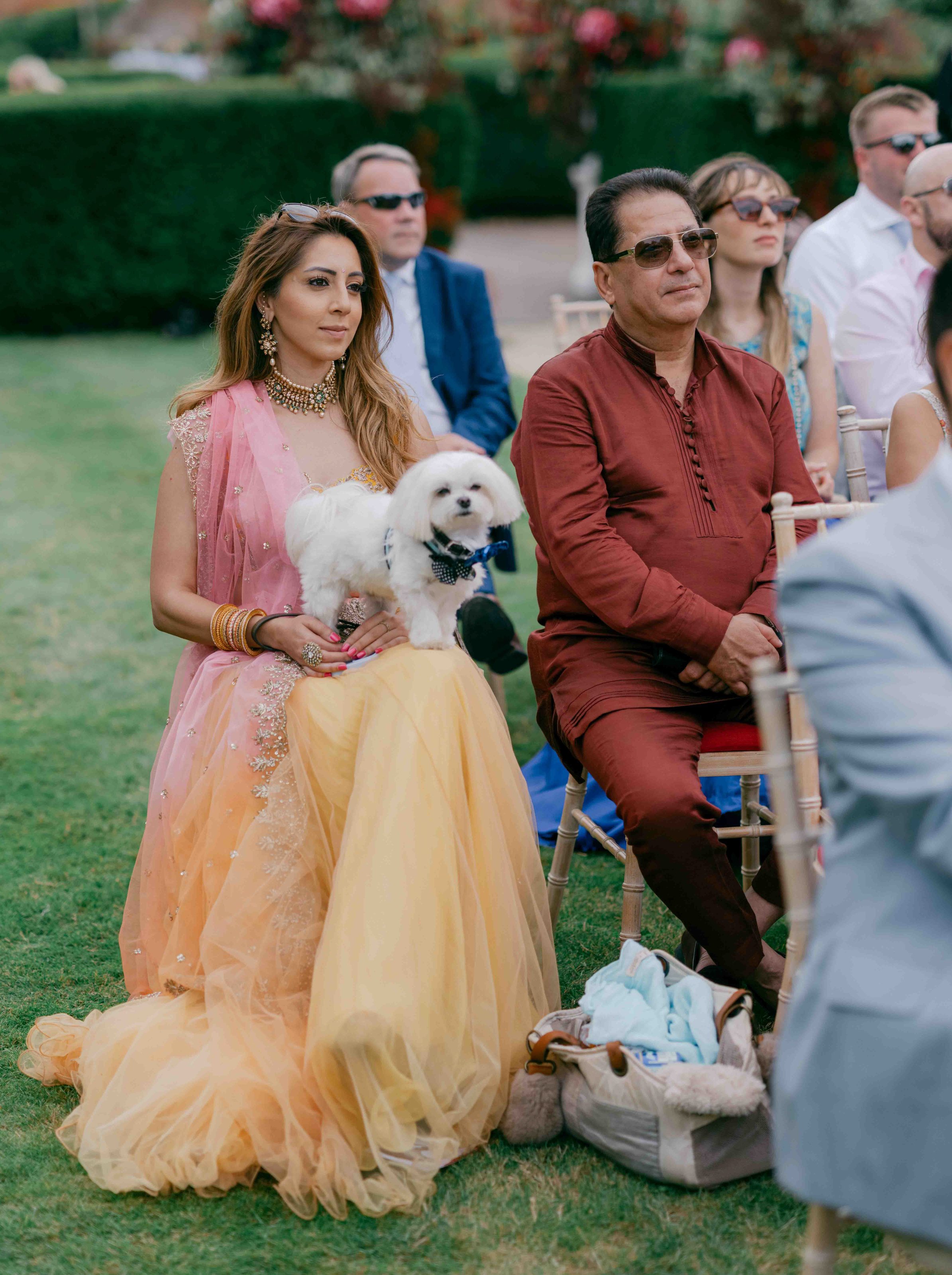  wedding guest sitting with their dog  