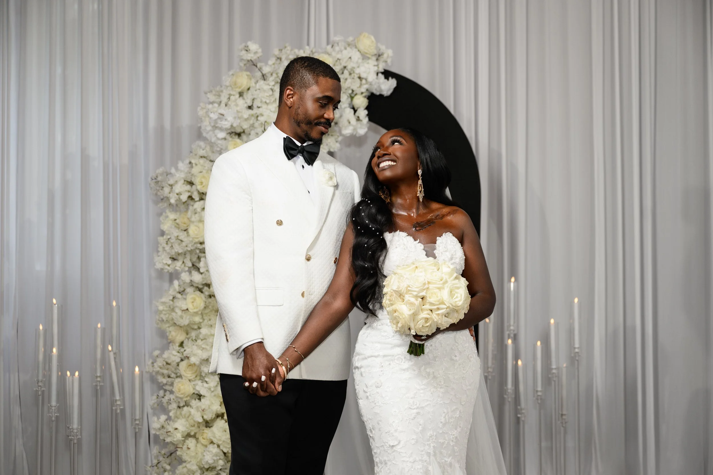 Jalisa and Sadiq looking at one another during their wedding portraits