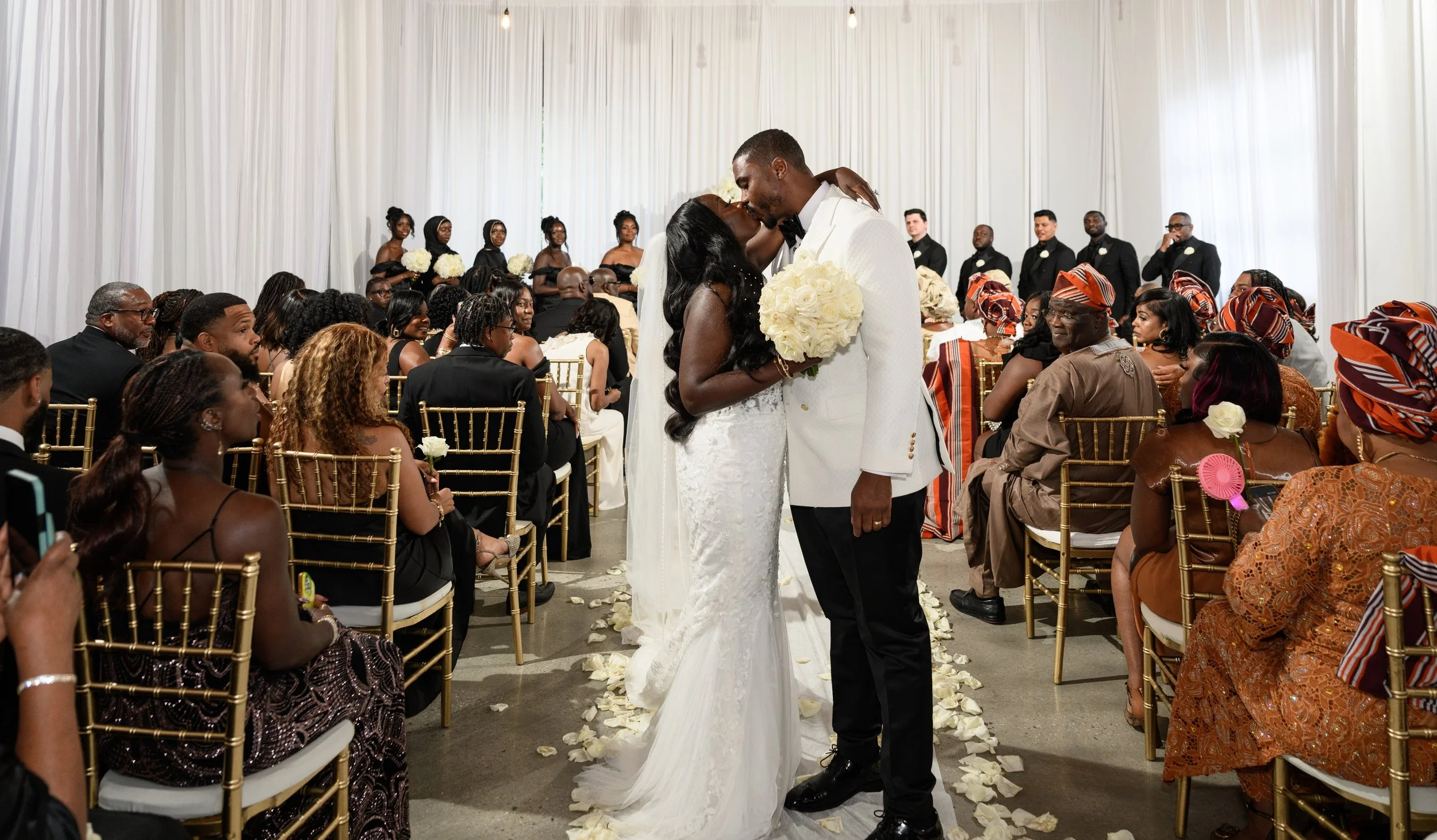 Newlyweds Jalisa and Sadiq walking back down the aisle after their ceremony