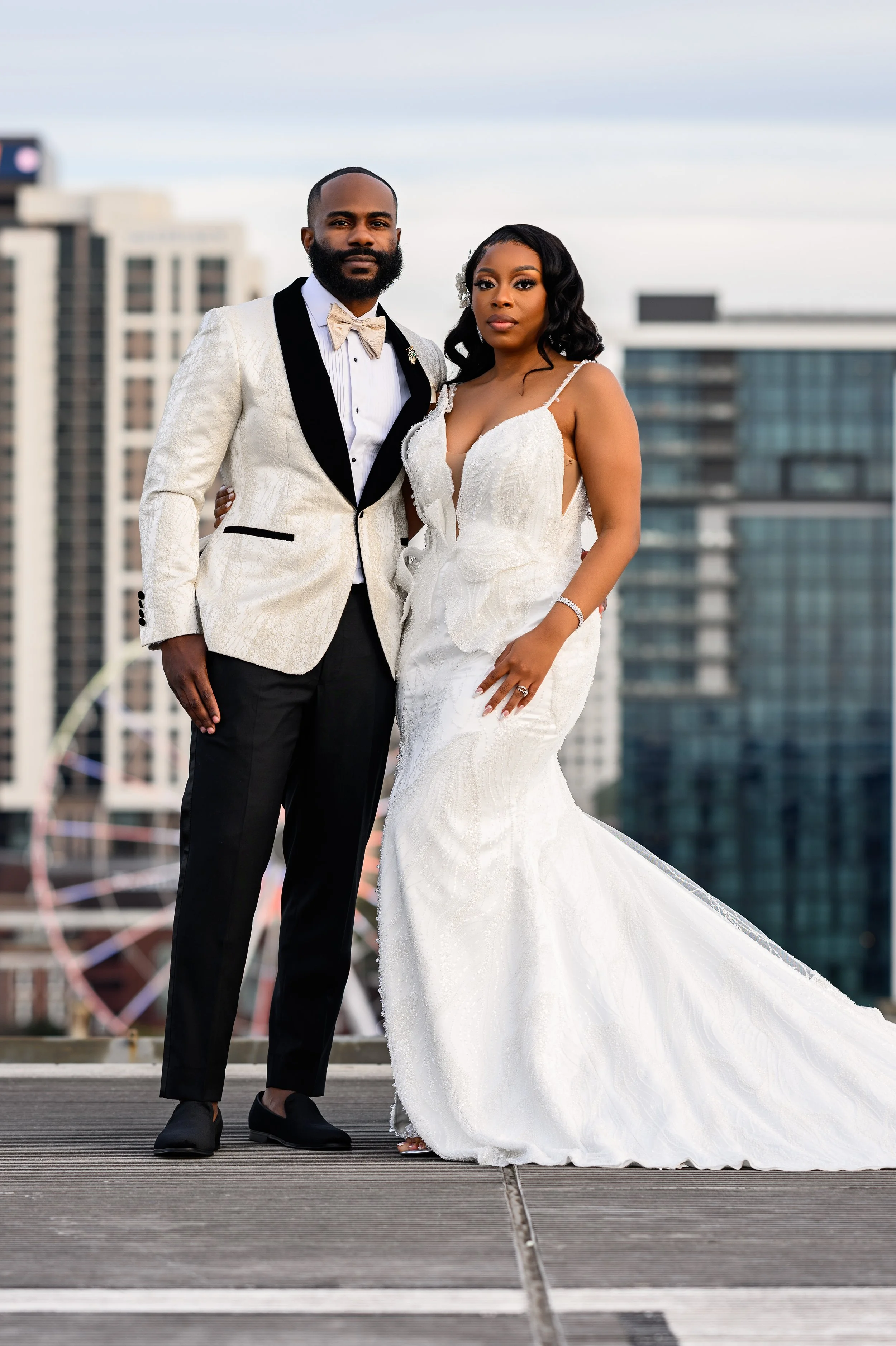 Shareze and Jacorey posing together with the Atlanta skyline behind them at Ventanas.