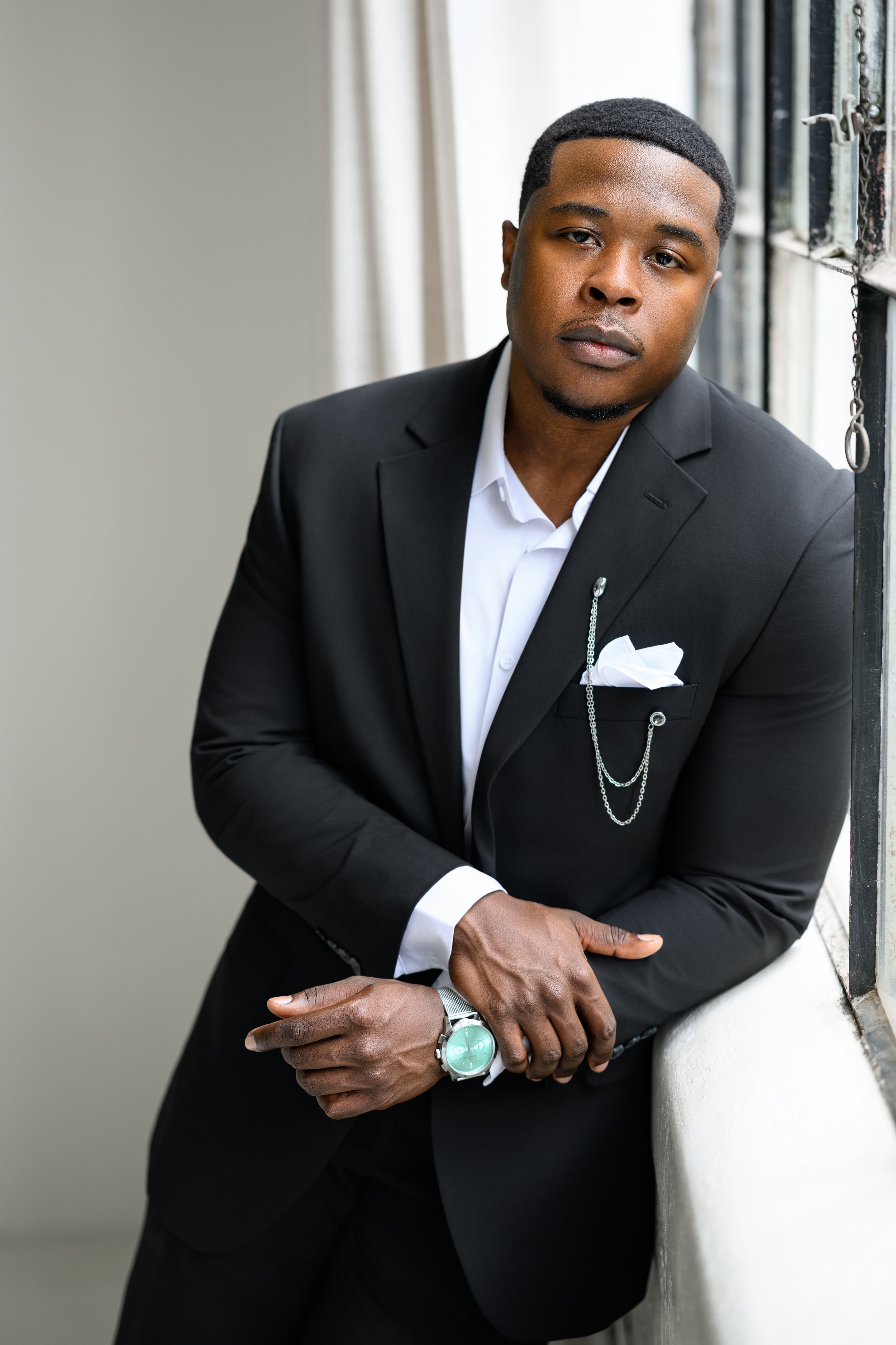 Chris photographed in a black tuxedo during his Atlanta engagement session with Denea.