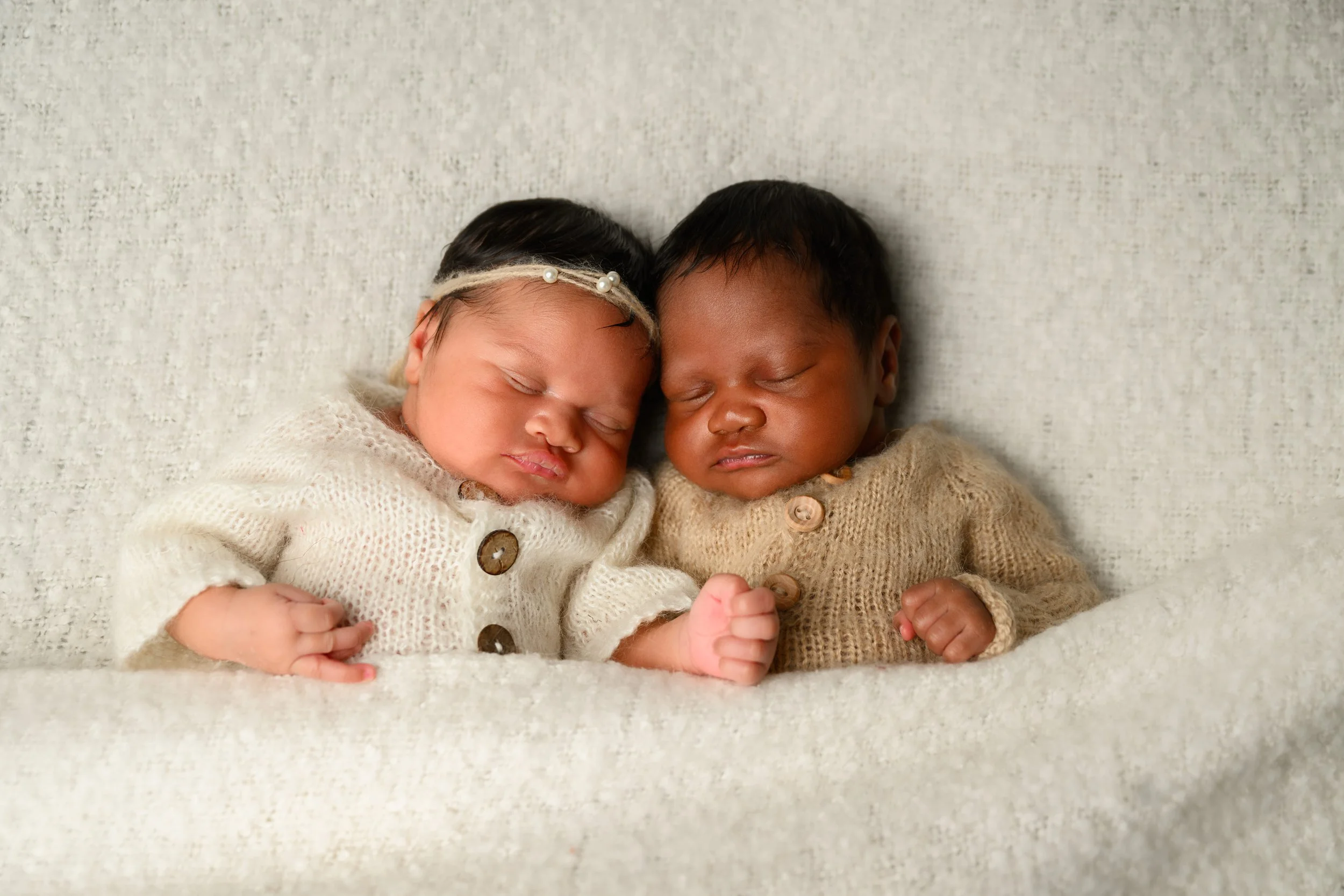 Close-up portrait of newborn twins sleeping together during their Atlanta newborn photography session.