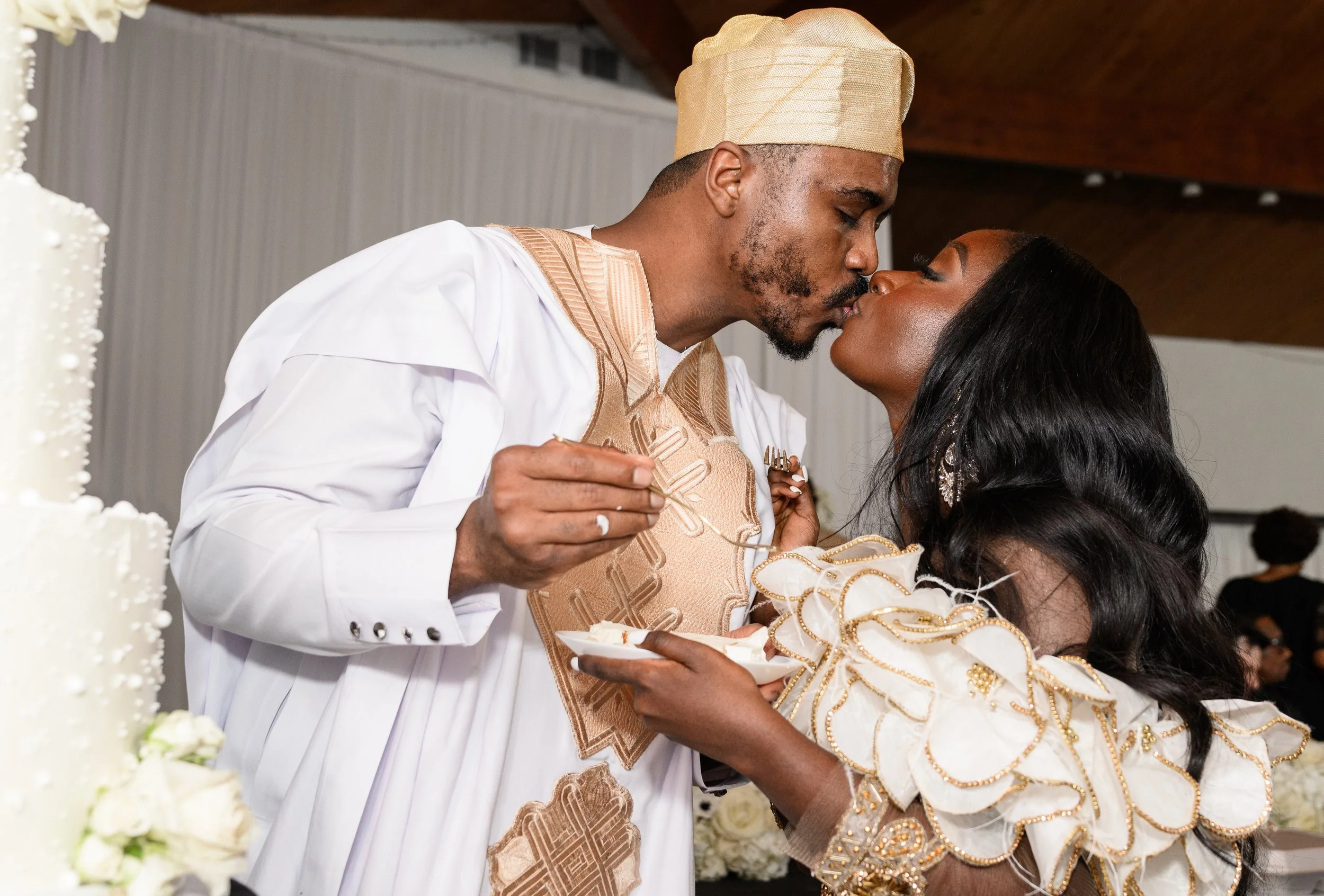 Jalisa and Sadiq sharing a kiss during their wedding reception