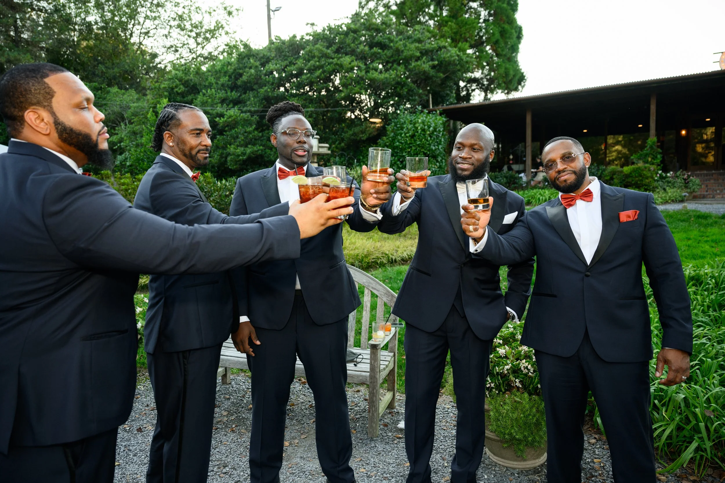Groomsmen raising glasses in a celebratory toast during Ashley and Jason’s intimate wedding dinner at Canoe Restaurant.