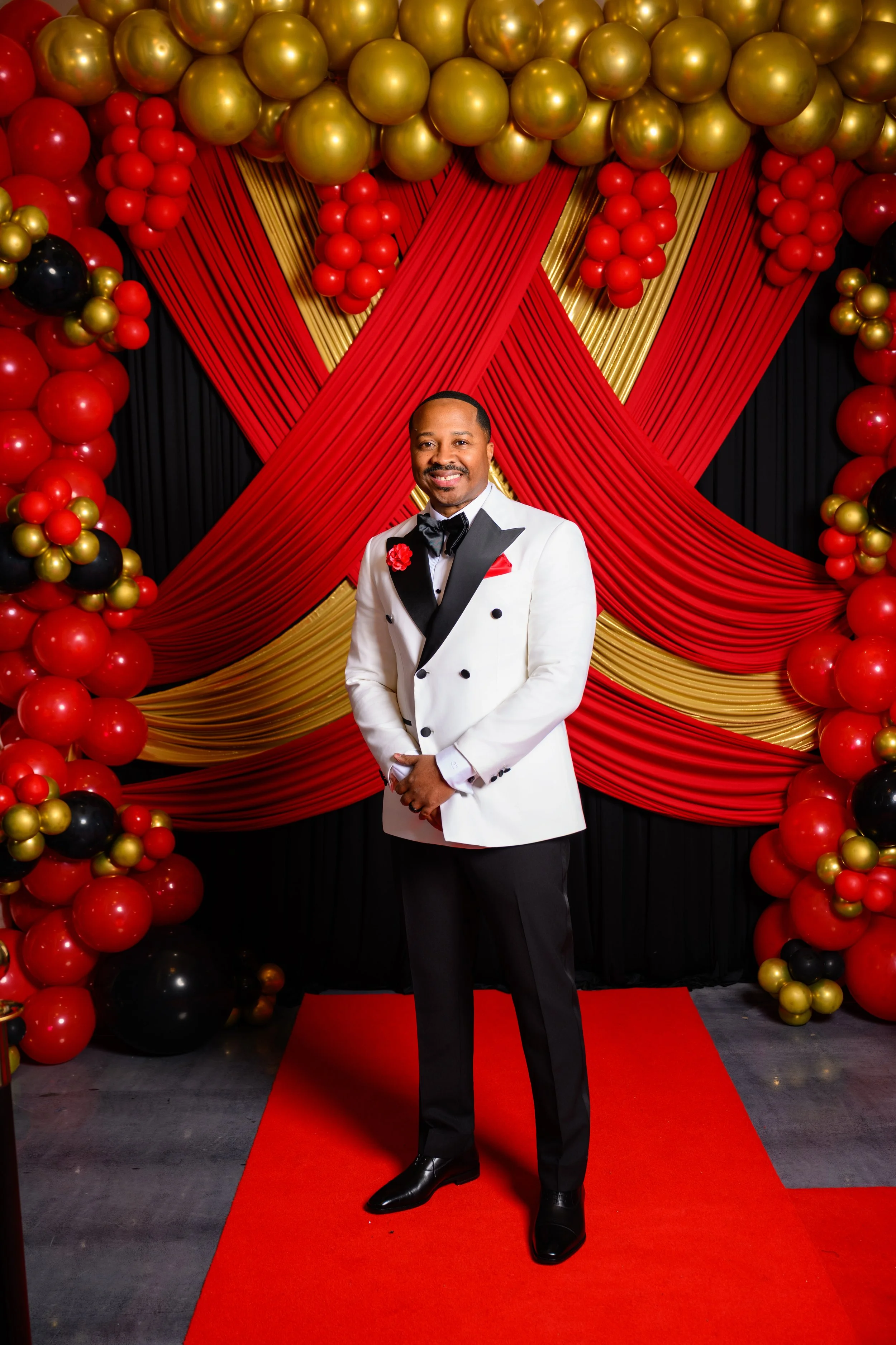 Warren celebrating his 50th birthday with a red carpet portrait at his Atlanta birthday celebration.