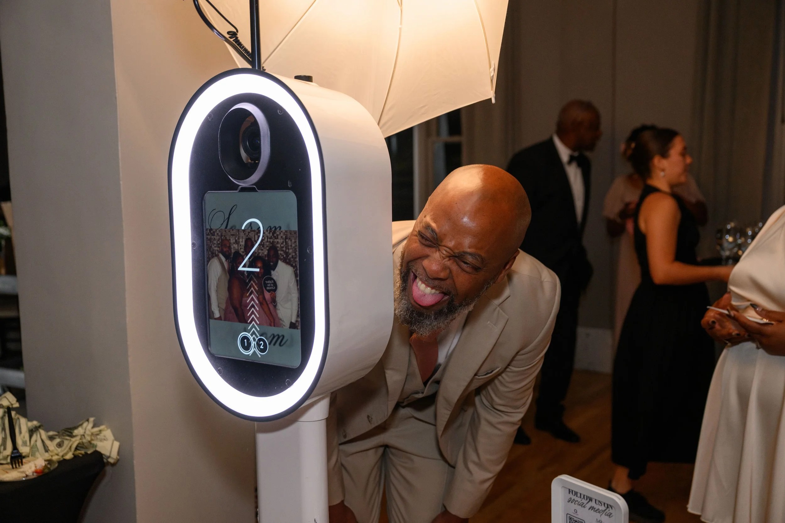 Guests enjoying the photo booth during Sherod and Sonya’s wedding reception.
