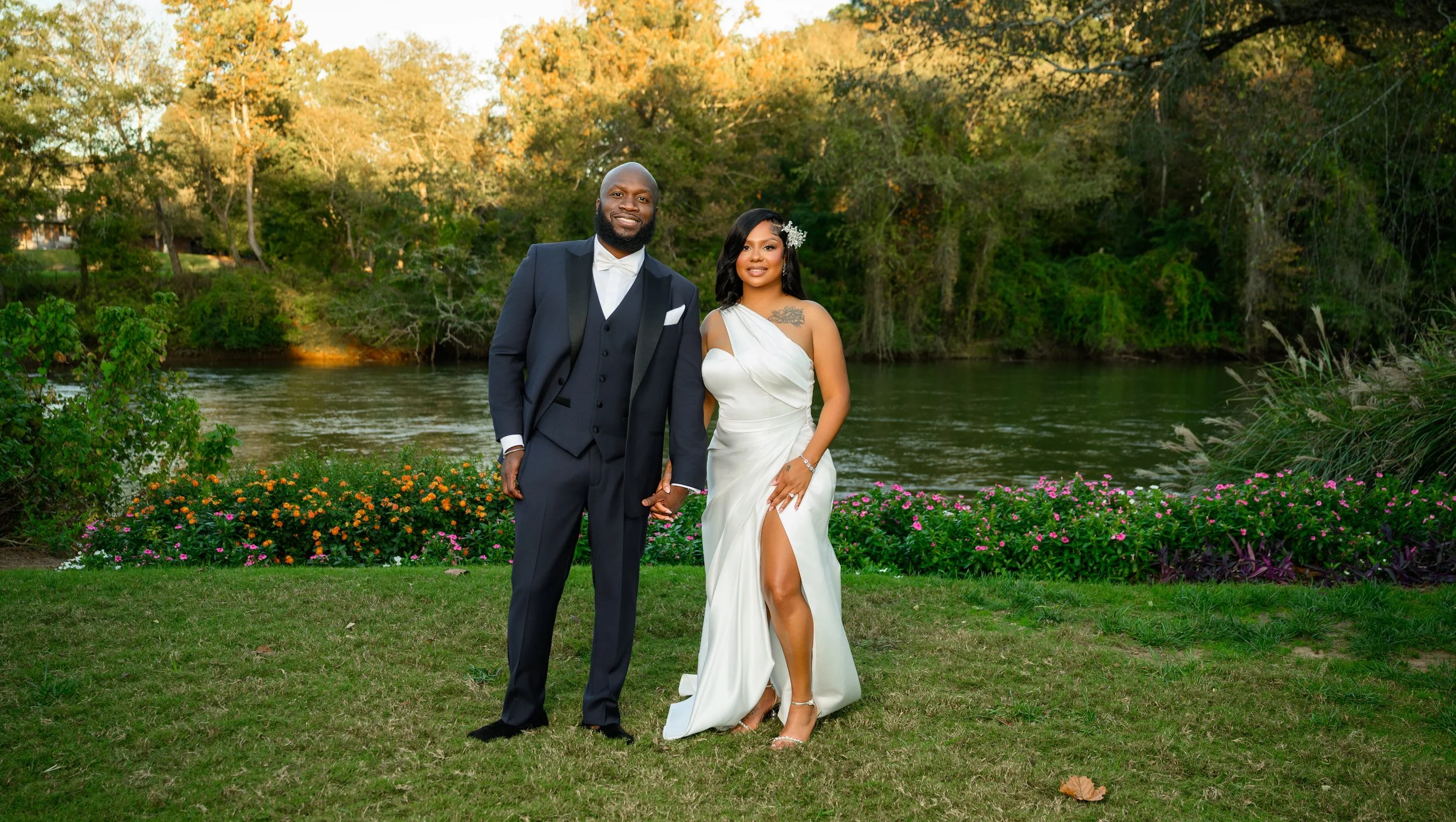 Bride and groom holding hands by the Chattahoochee River during their intimate fall wedding at Canoe Restaurant in Atlanta.