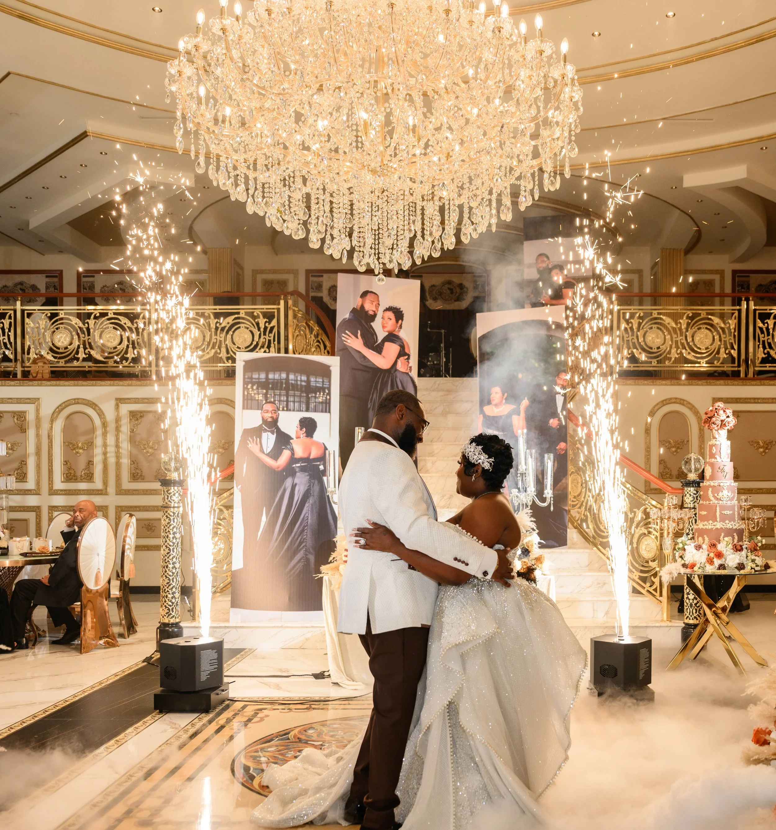 Newlyweds sharing their first dance surrounded by cold sparks at their Shahbain Events Center wedding reception.