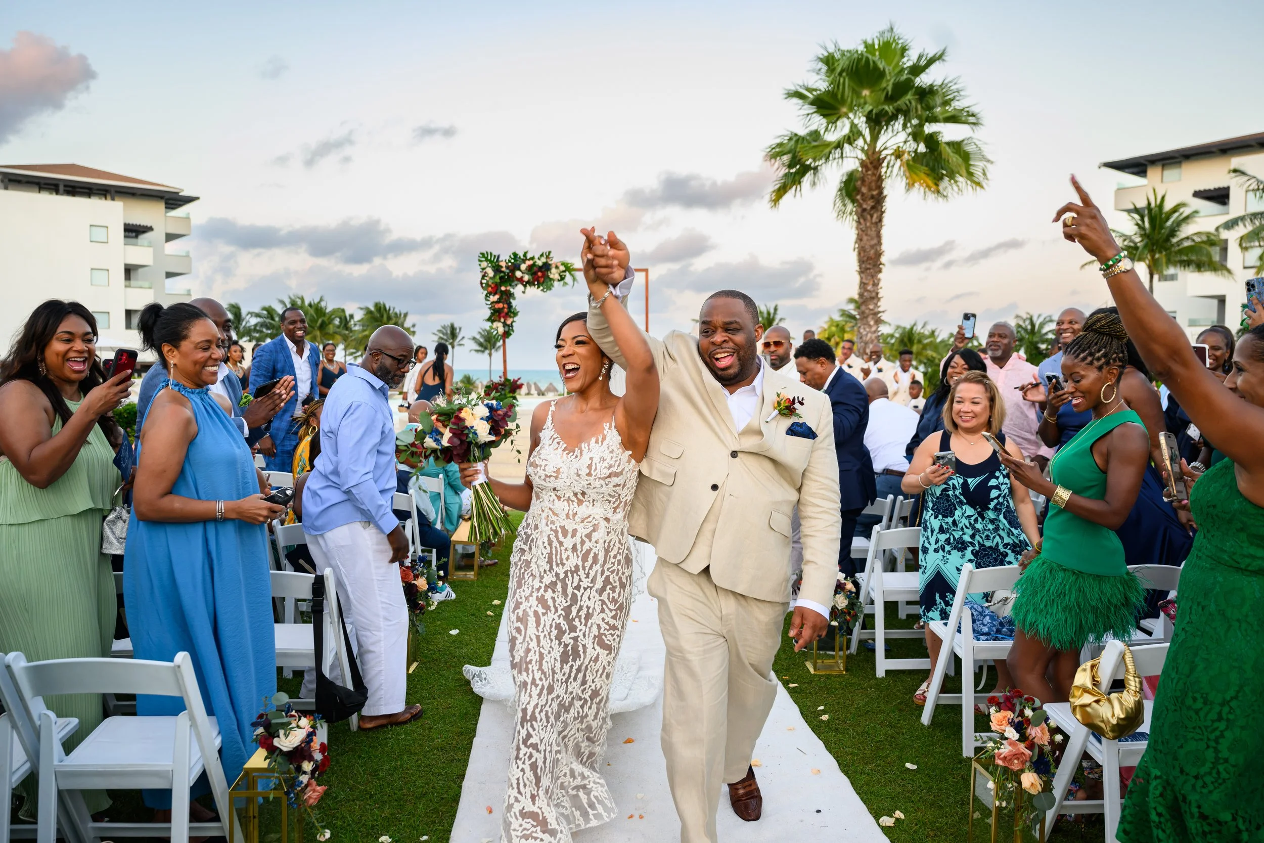 Newlyweds Tekla and Rick celebrating with guests after their Cancun wedding ceremony.