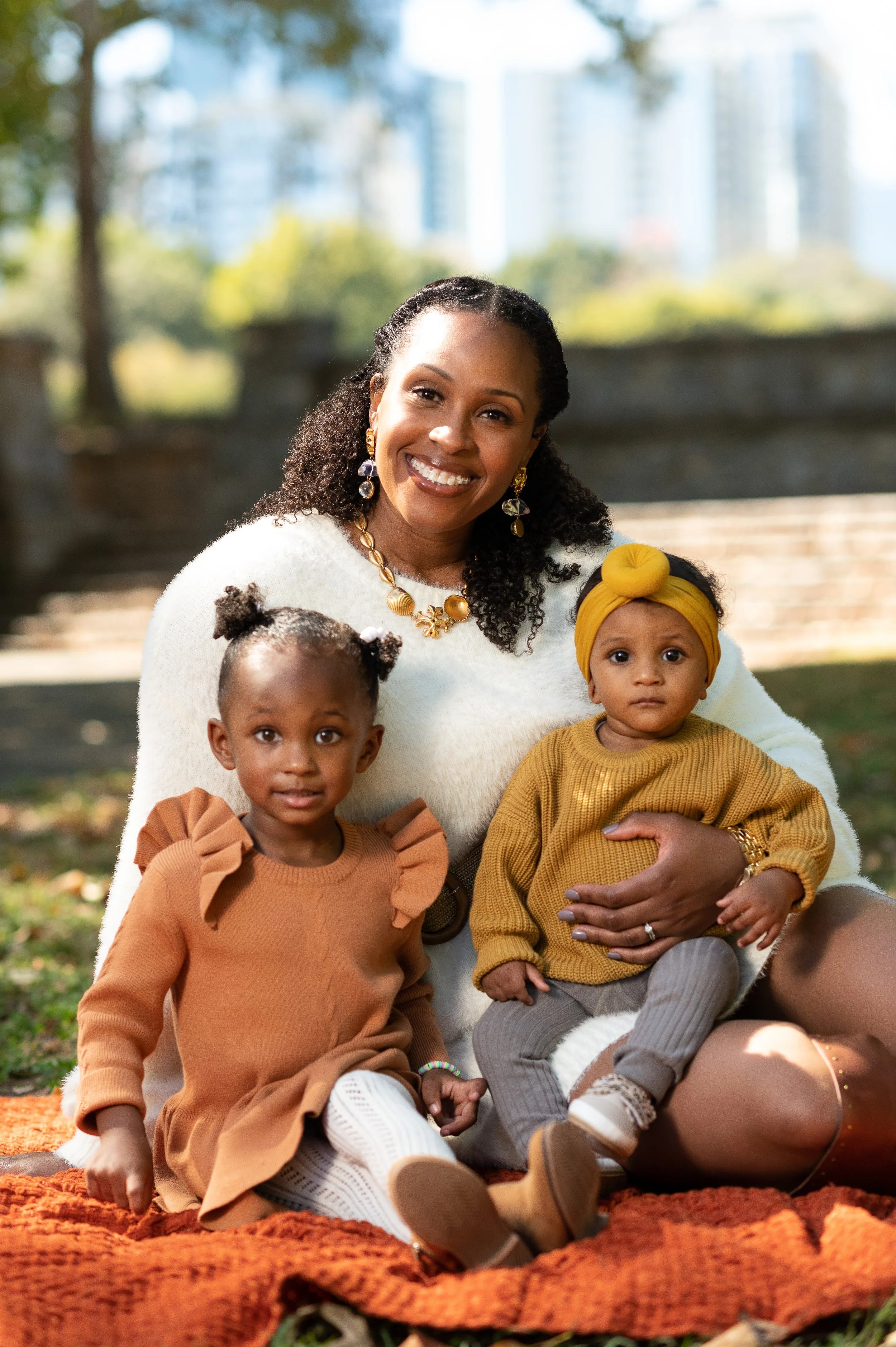 Mother with her two daughters during a family photography session at Piedmont Park in Atlanta.