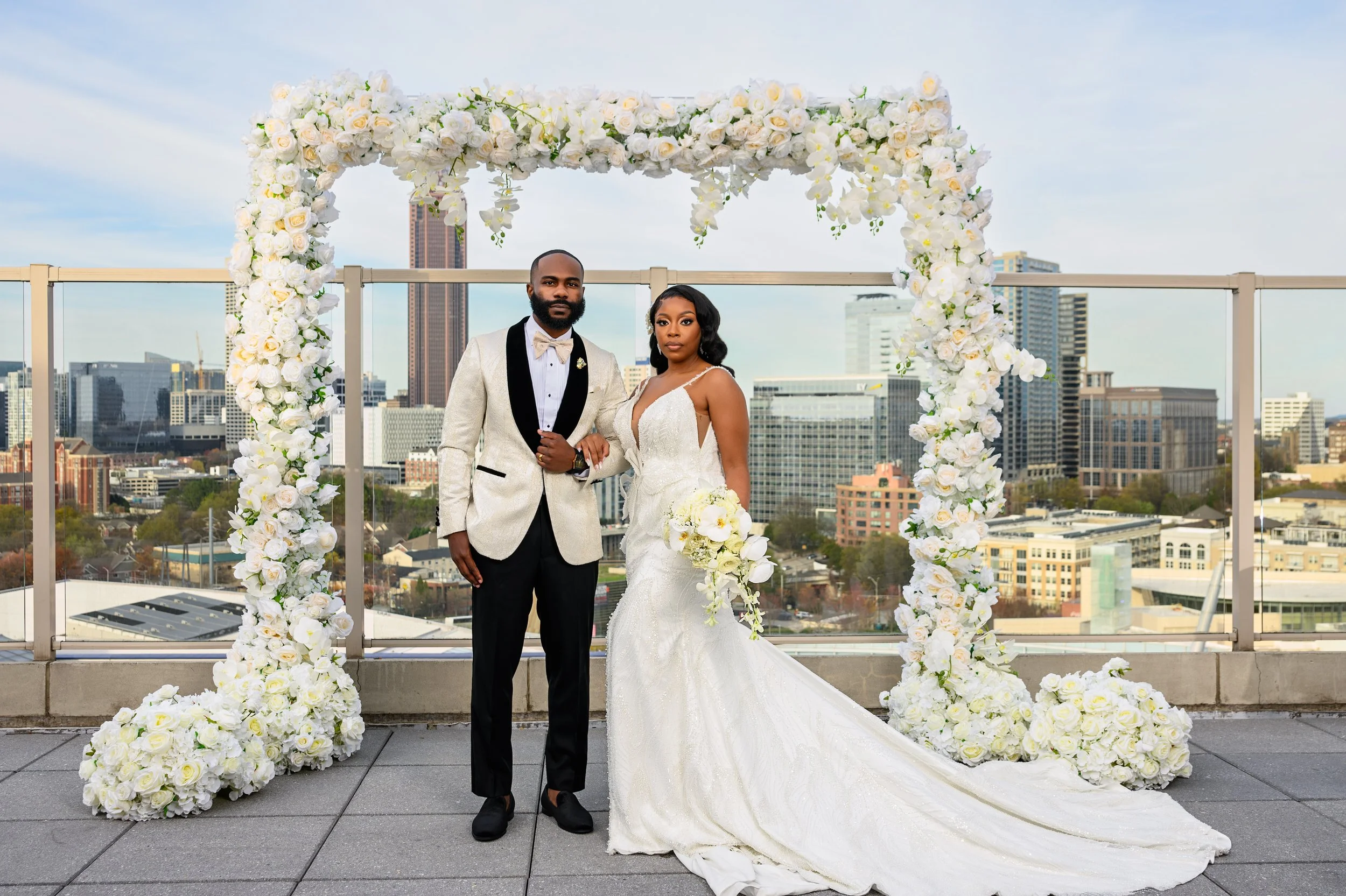 Shareze and Jacorey together beneath their floral ceremony arch at Ventanas in Atlanta.