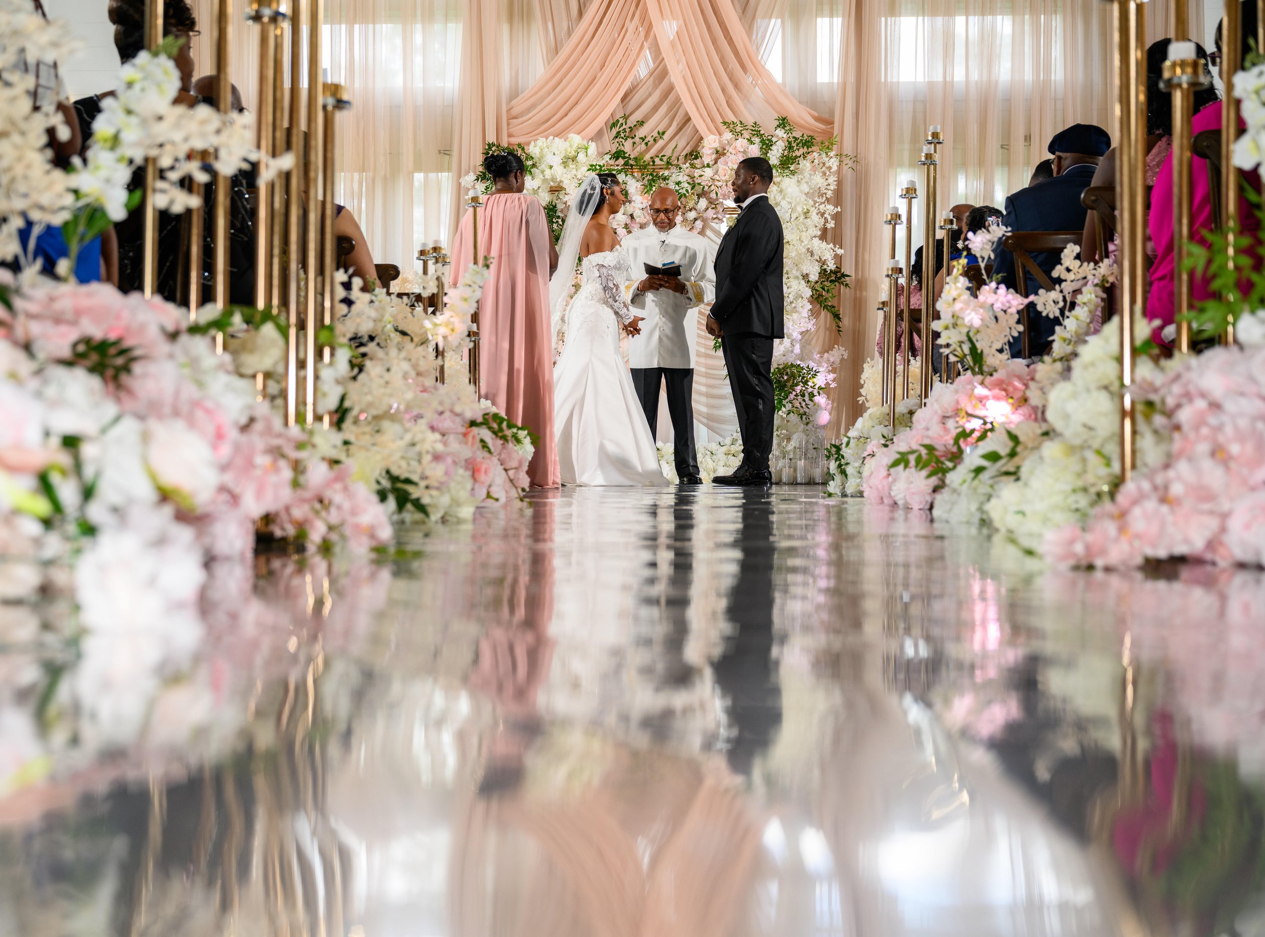 Bride and groom standing at the altar during their floral wedding ceremony at The Venue at Daisy Hill.