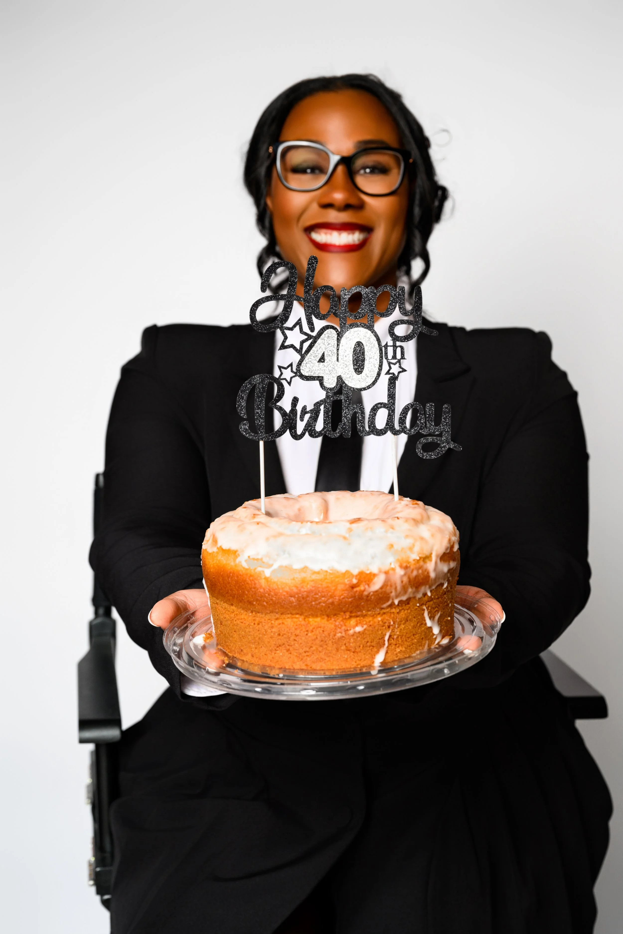 Tempestt holding her 40th birthday cake during a milestone portrait photography session in Atlanta.