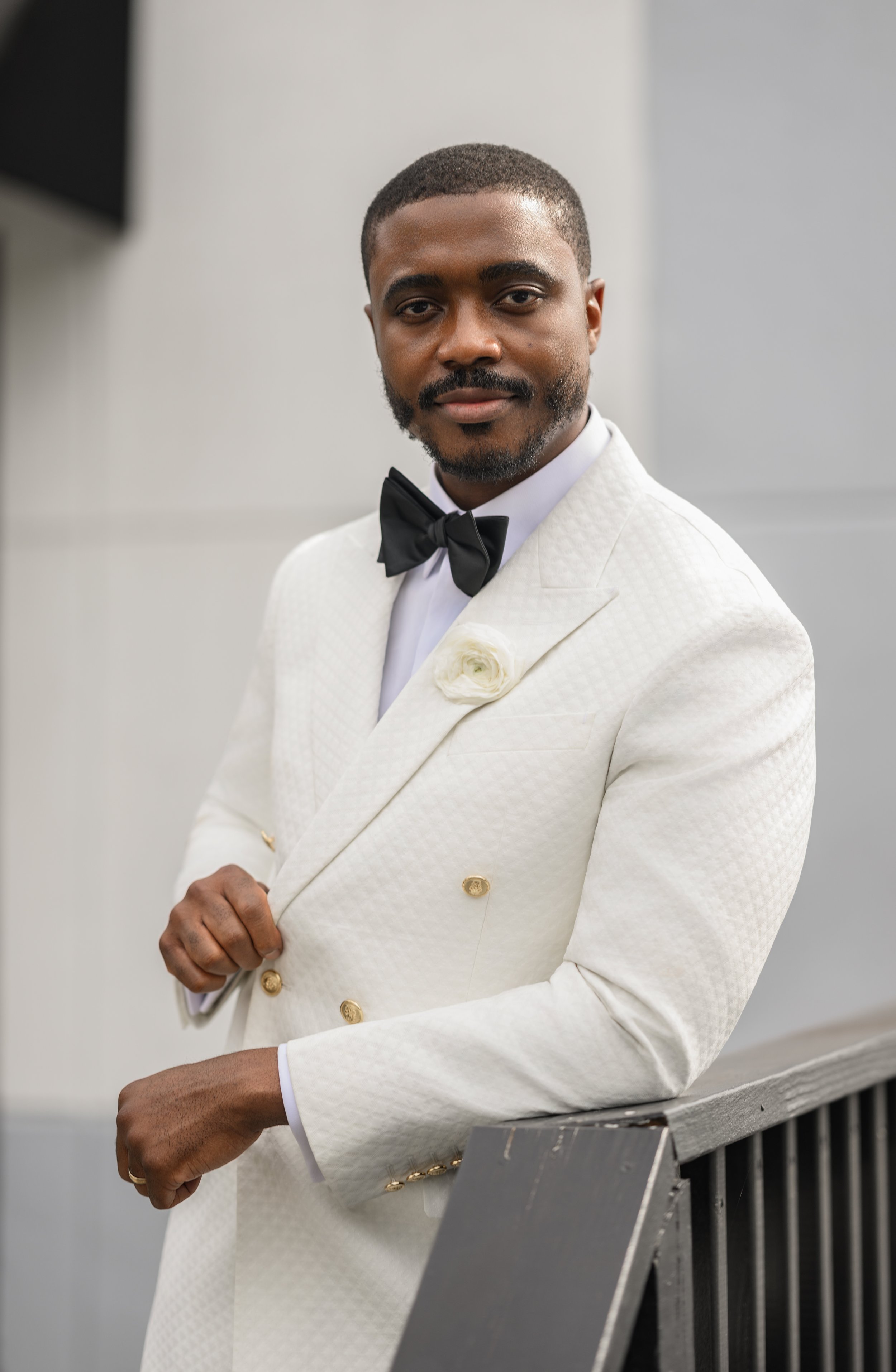 Sadiq photographed in his white tuxedo on his wedding day at The West Venue