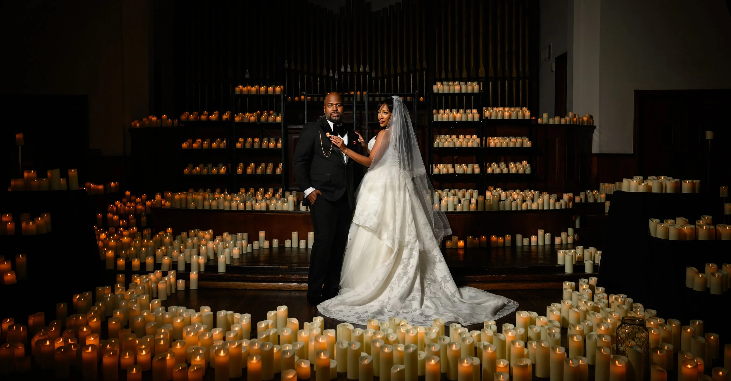 Bride and groom surrounded by hundreds of glowing candles during their Atlanta wedding portrait.