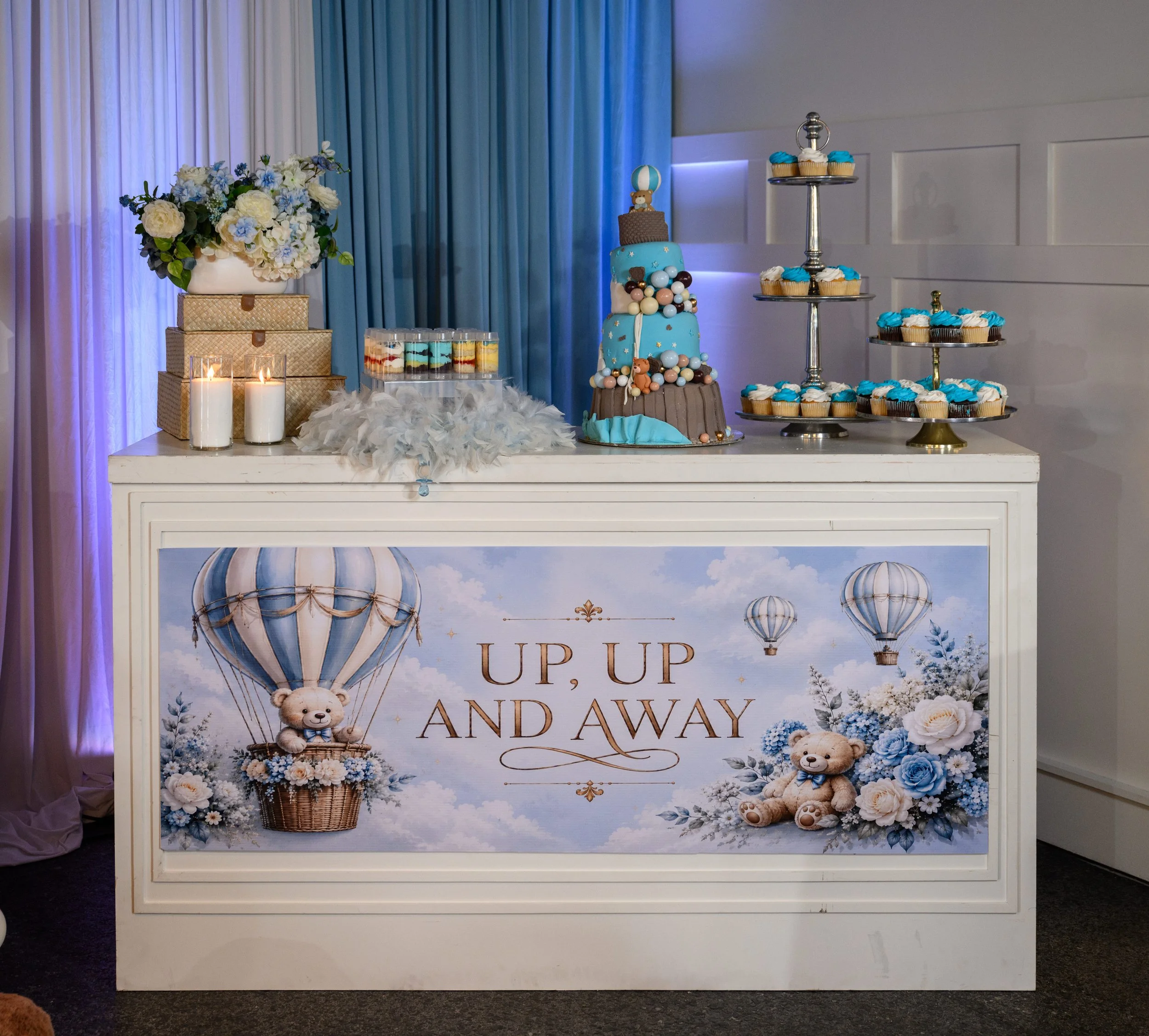 Up, Up and Away baby shower dessert display with blue teddy bear and hot air balloon details in Flowery Branch, Georgia.
