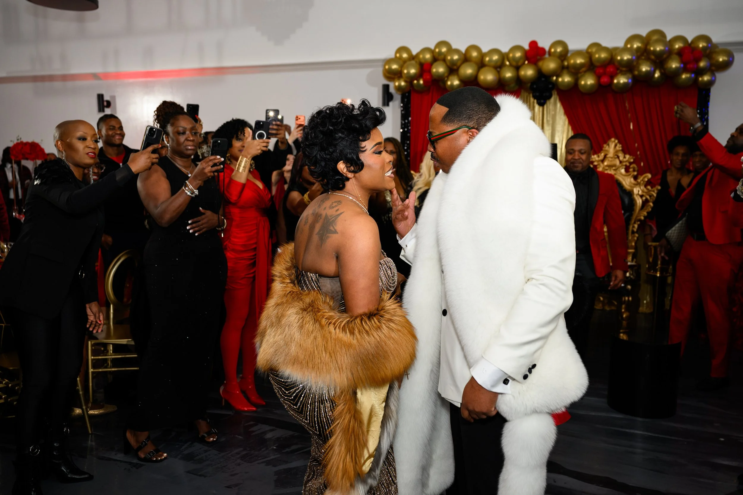 Guests surrounding Warren during an energetic moment at his 50th birthday party in Atlanta.