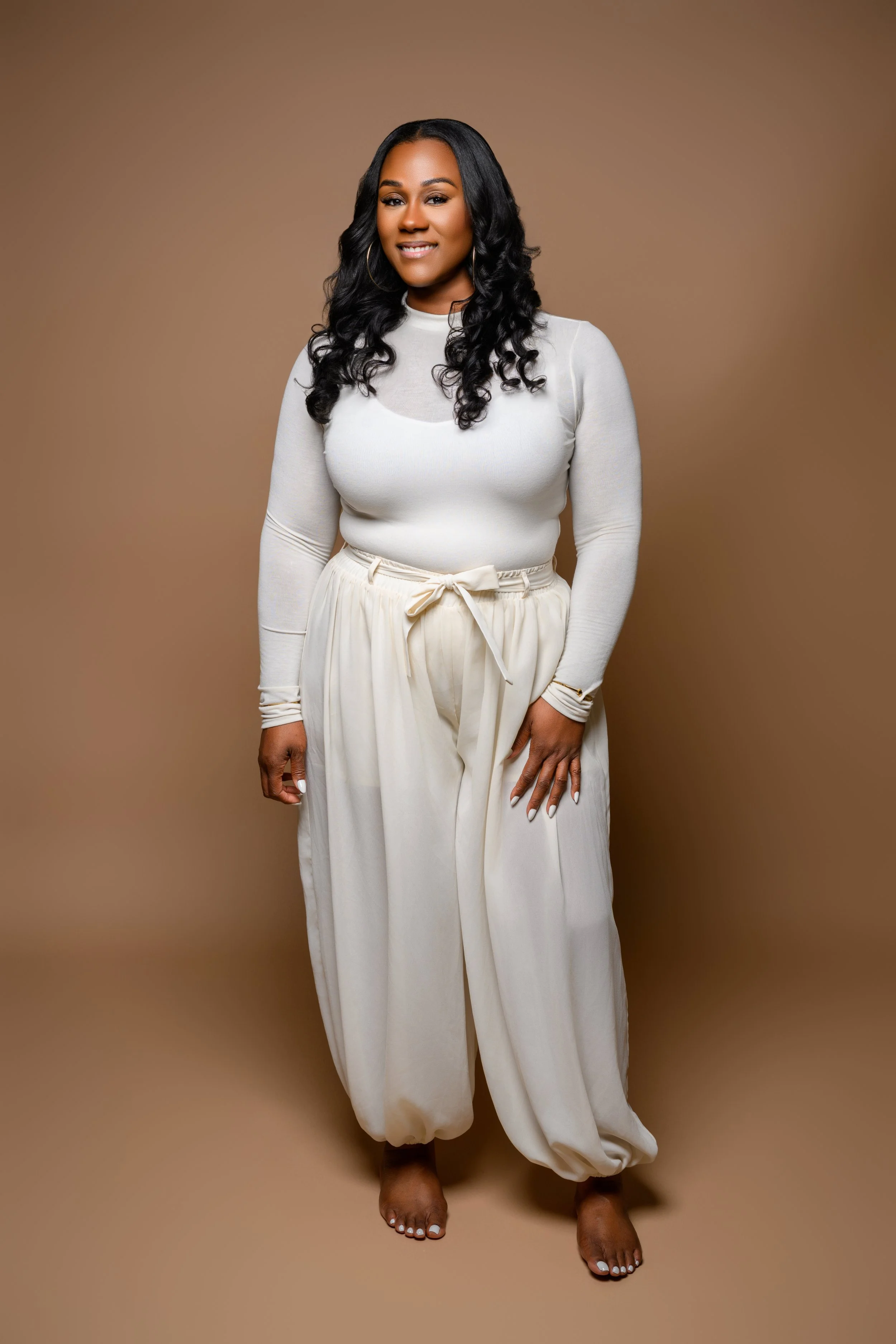 Tempestt wearing a cream outfit during an Atlanta milestone portrait session.